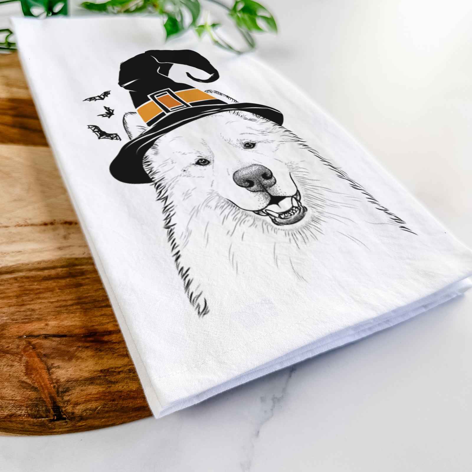 Hand-drawn sketch of Foster the Samoyed wearing a witch hat on a tea towel