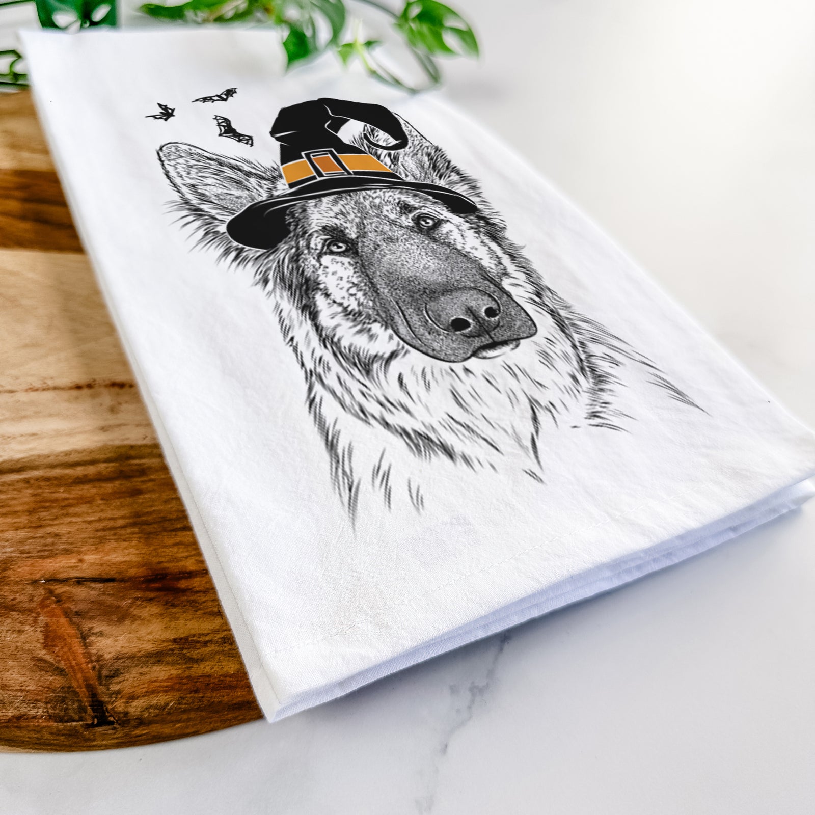 Hand-drawn sketch of Geddy the Shiloh Shepherd wearing a witch hat on a tea towel