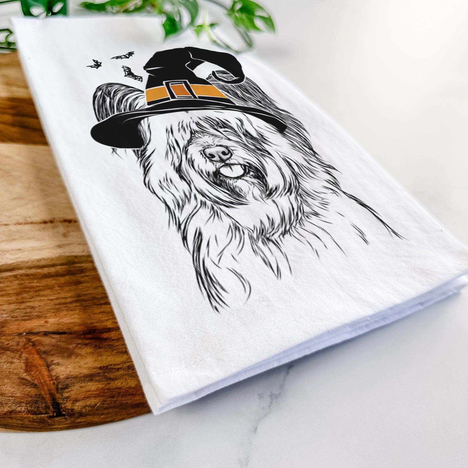Hand-drawn sketch of Gideon the Skye Terrier wearing a witch hat on a tea towel