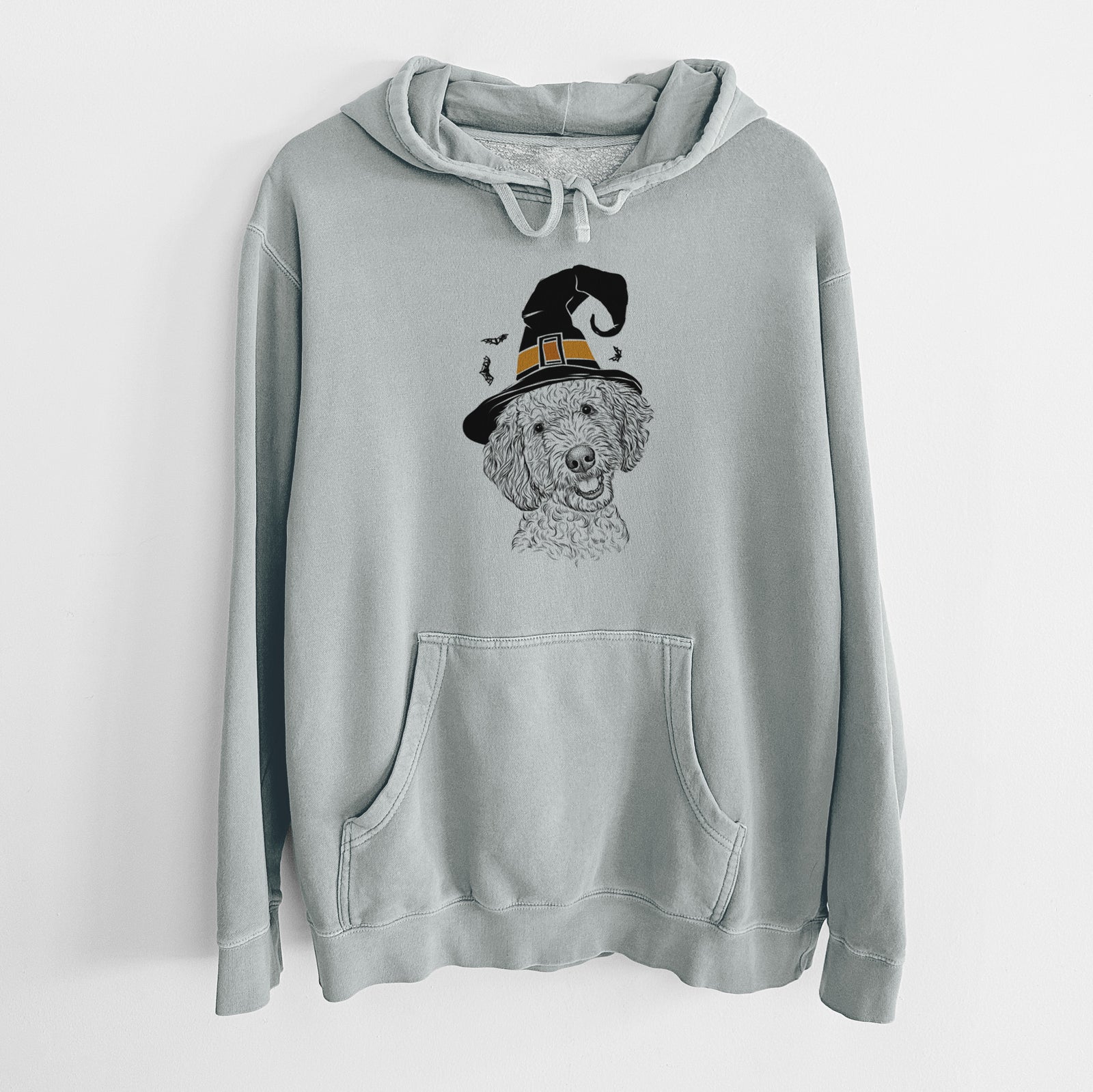 Hand-drawn sketch of Gizmo the Goldendoodle wearing a witch hat on a Sage Unisex pigment dyed hoodie