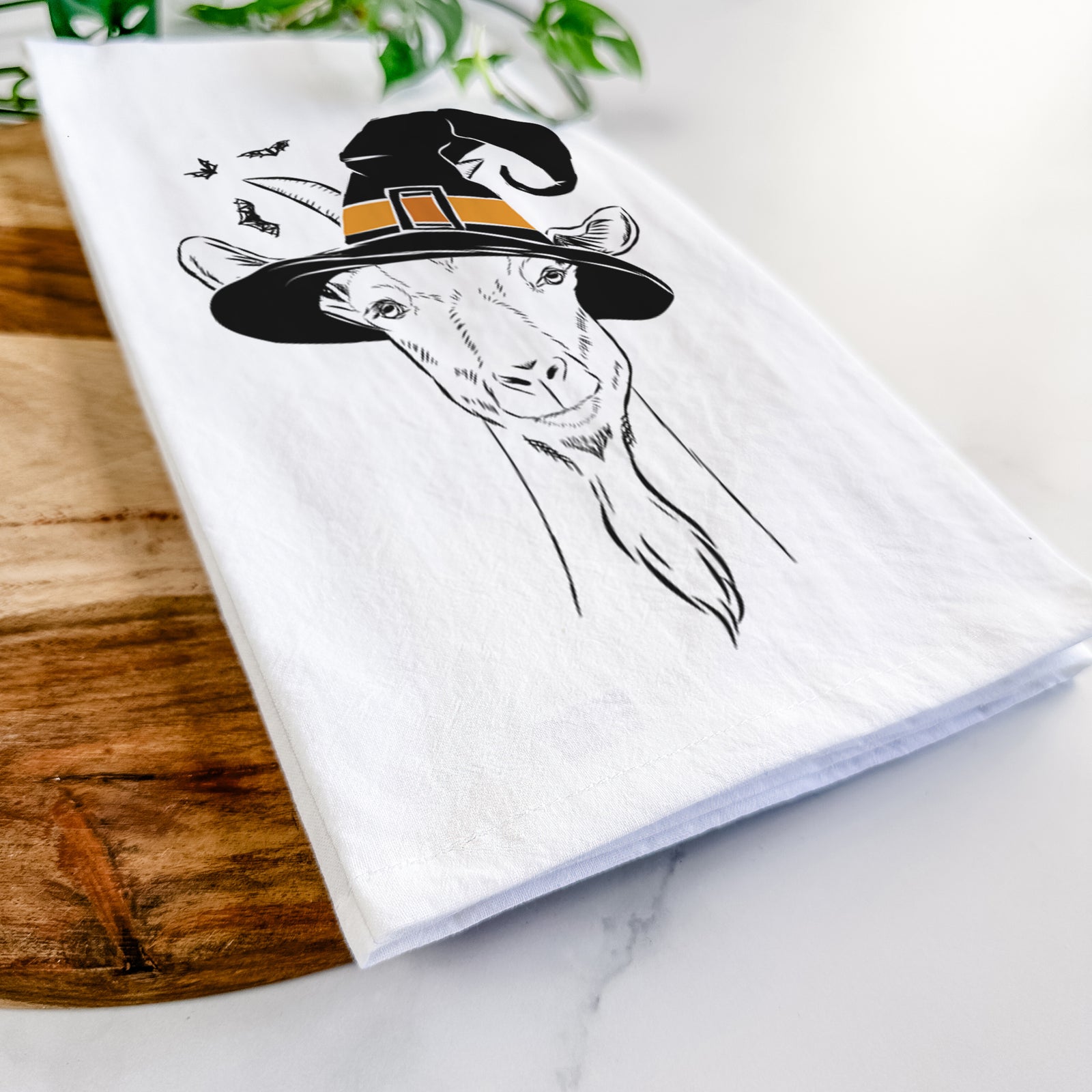Hand-drawn sketch of Gunnar the Goat wearing a witch hat on a tea towel