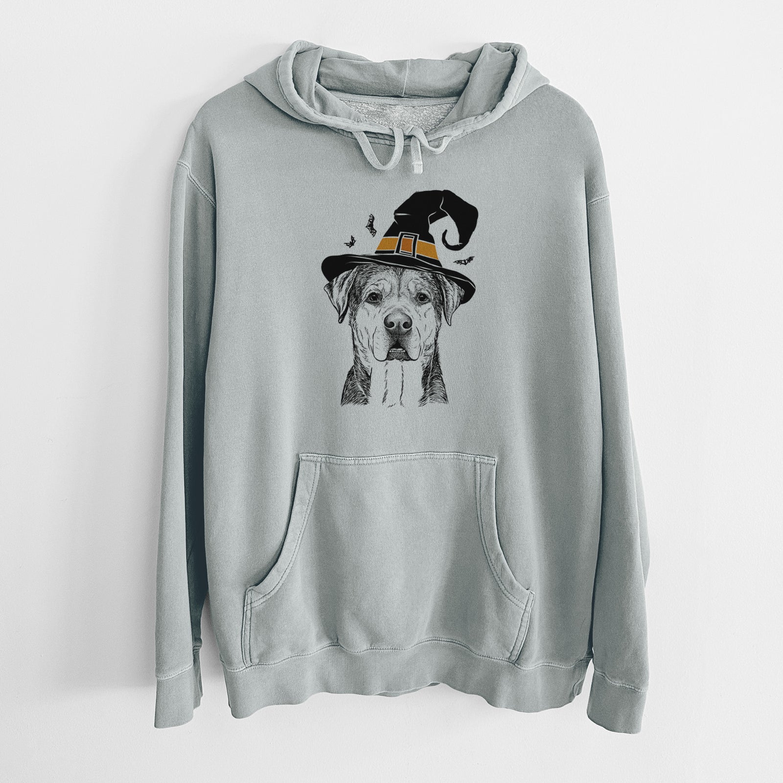 Hand-drawn sketch of Gus the Rottweiler Mix wearing a witch hat on a Sage Unisex pigment dyed hoodie