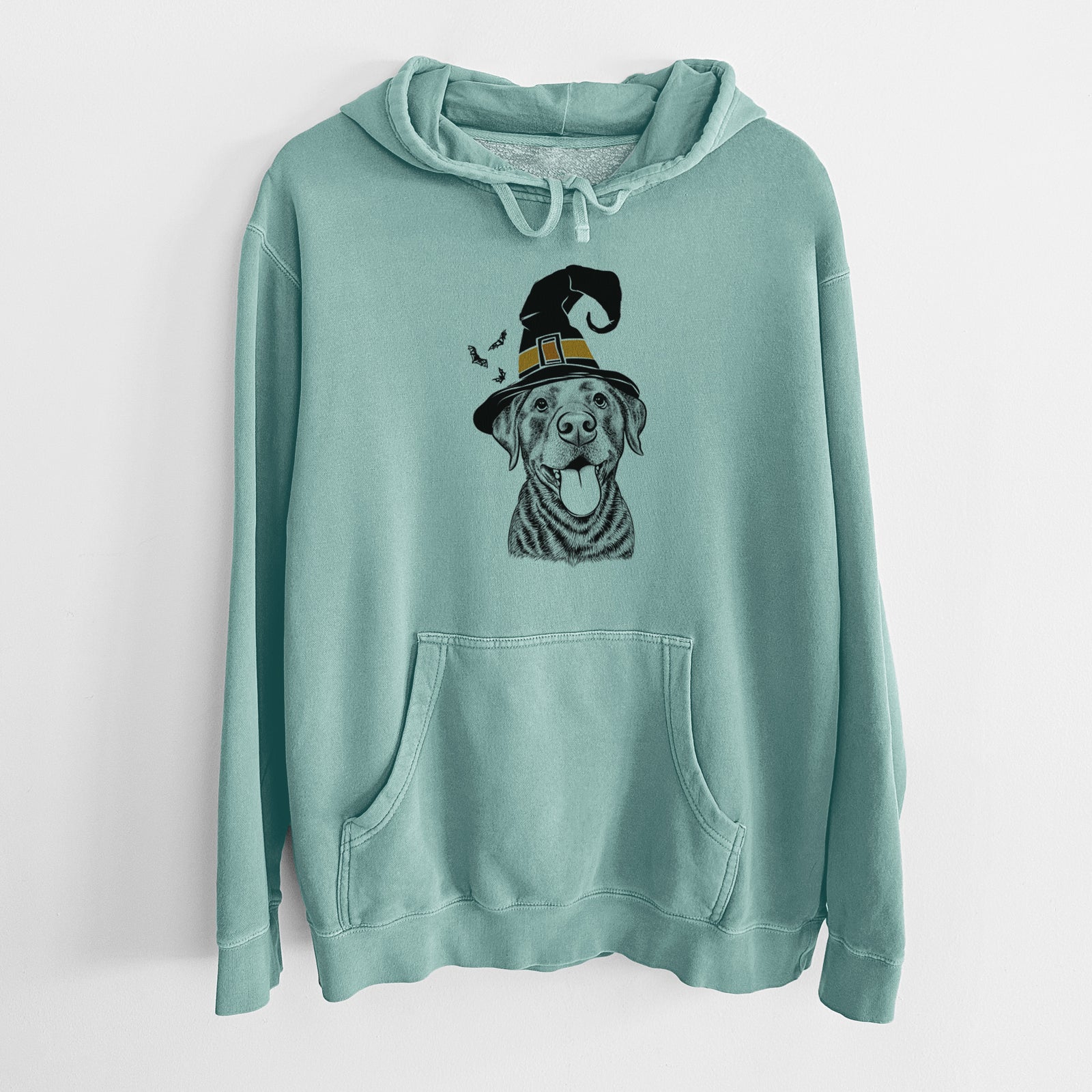Hand-drawn sketch of Gwen the Labrador Retriever wearing a witch hat on a Mint Unisex pigment dyed hoodie