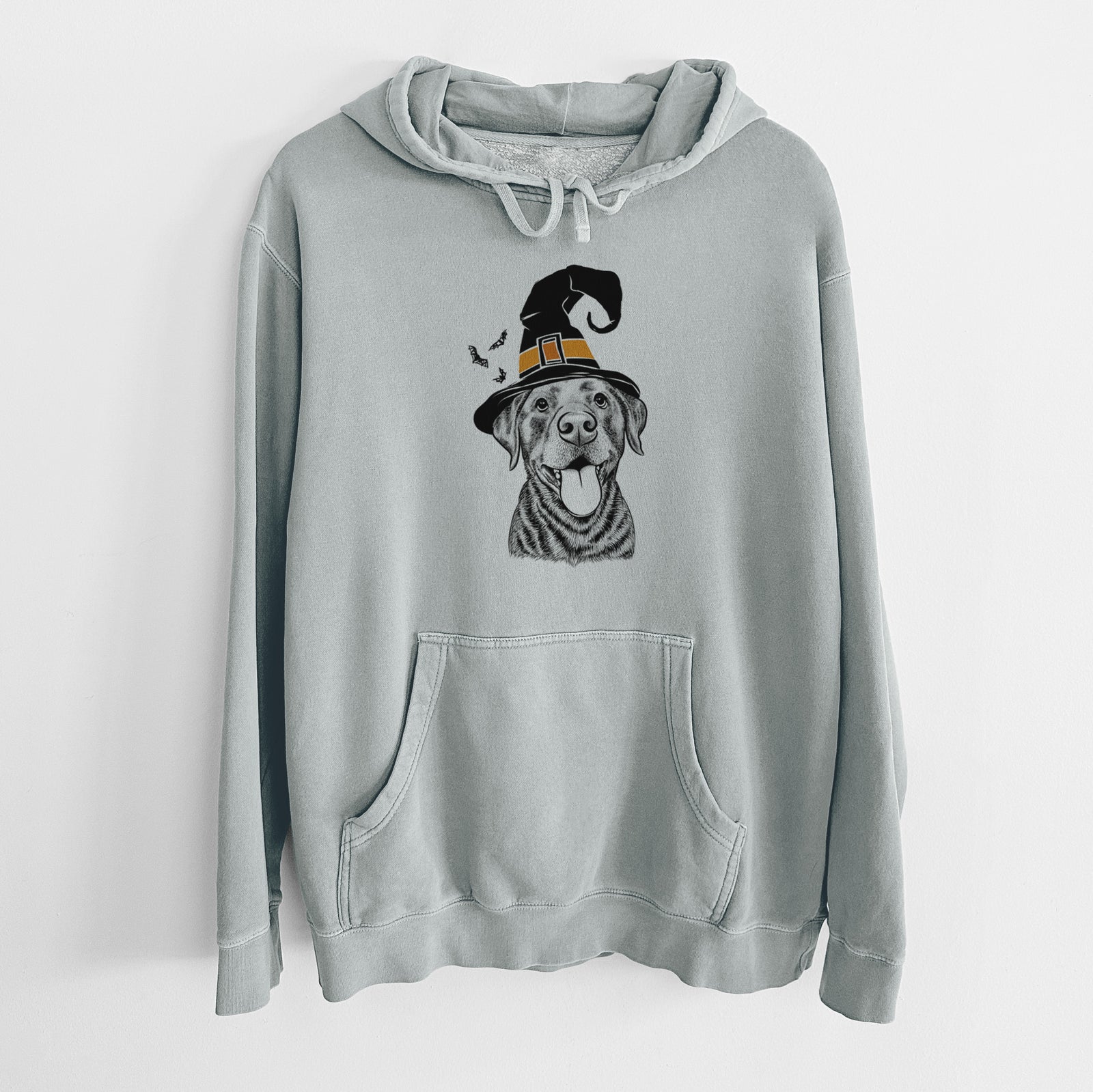 Hand-drawn sketch of Gwen the Labrador Retriever wearing a witch hat on a Sage Unisex pigment dyed hoodie
