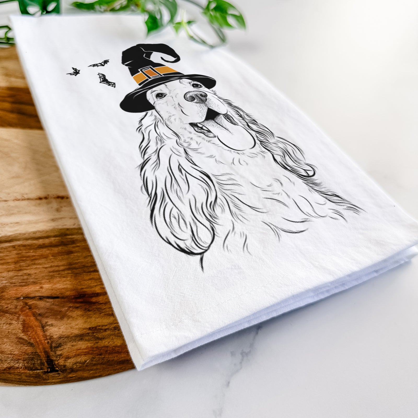 Hand-drawn sketch of Happy Henry the English Cocker Spaniel wearing a witch hat on a tea towel