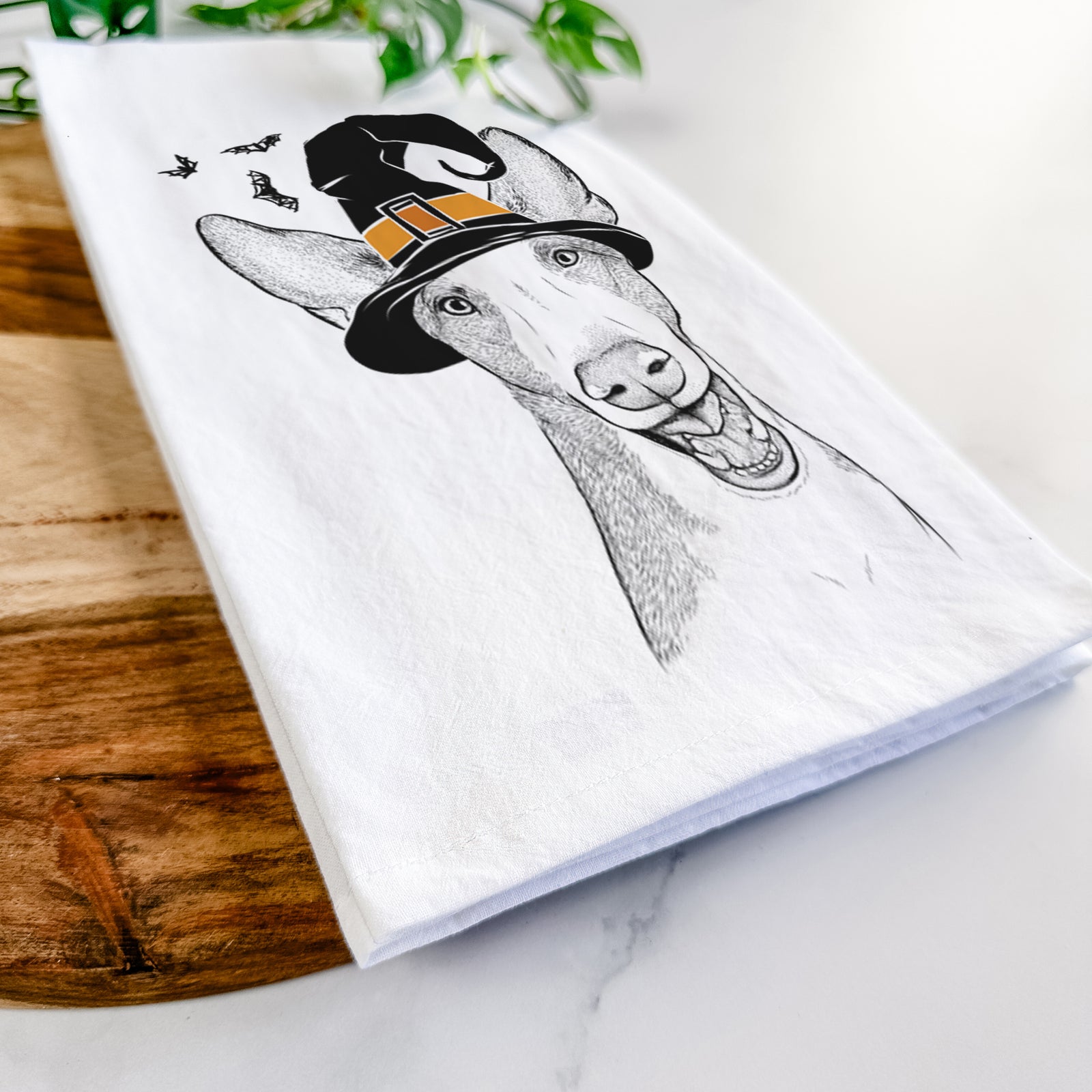 Hand-drawn sketch of Havok the Ibizan Hound wearing a witch hat on a tea towel