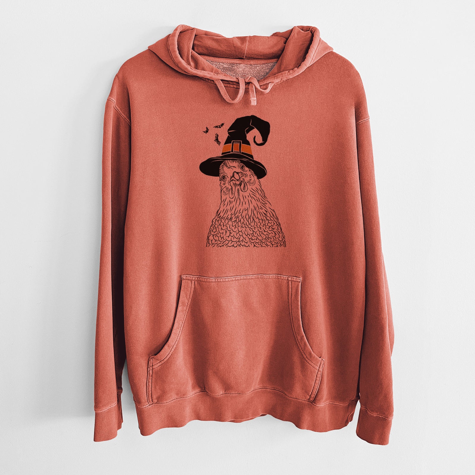 Hand-drawn sketch of Henrietta the Chicken wearing a witch hat on an Amber Unisex pigment dyed hoodie