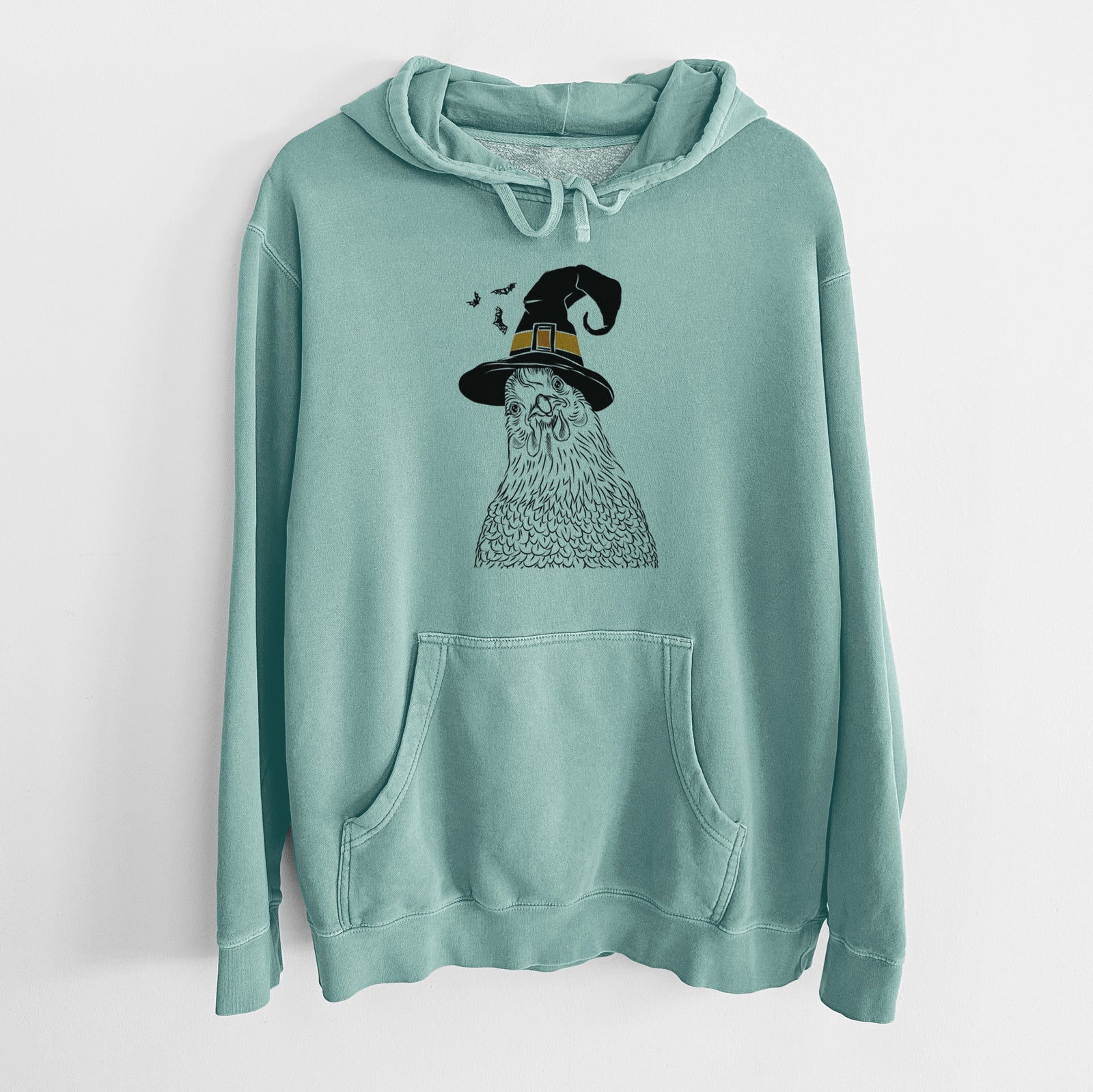 Hand-drawn sketch of Henrietta the Chicken wearing a witch hat on a Mint Unisex pigment dyed hoodie