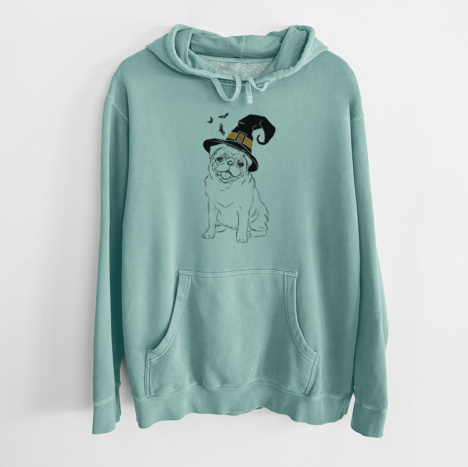 Hand-drawn sketch of Higgins the Pug wearing a witch hat on a Mint Unisex pigment dyed hoodie