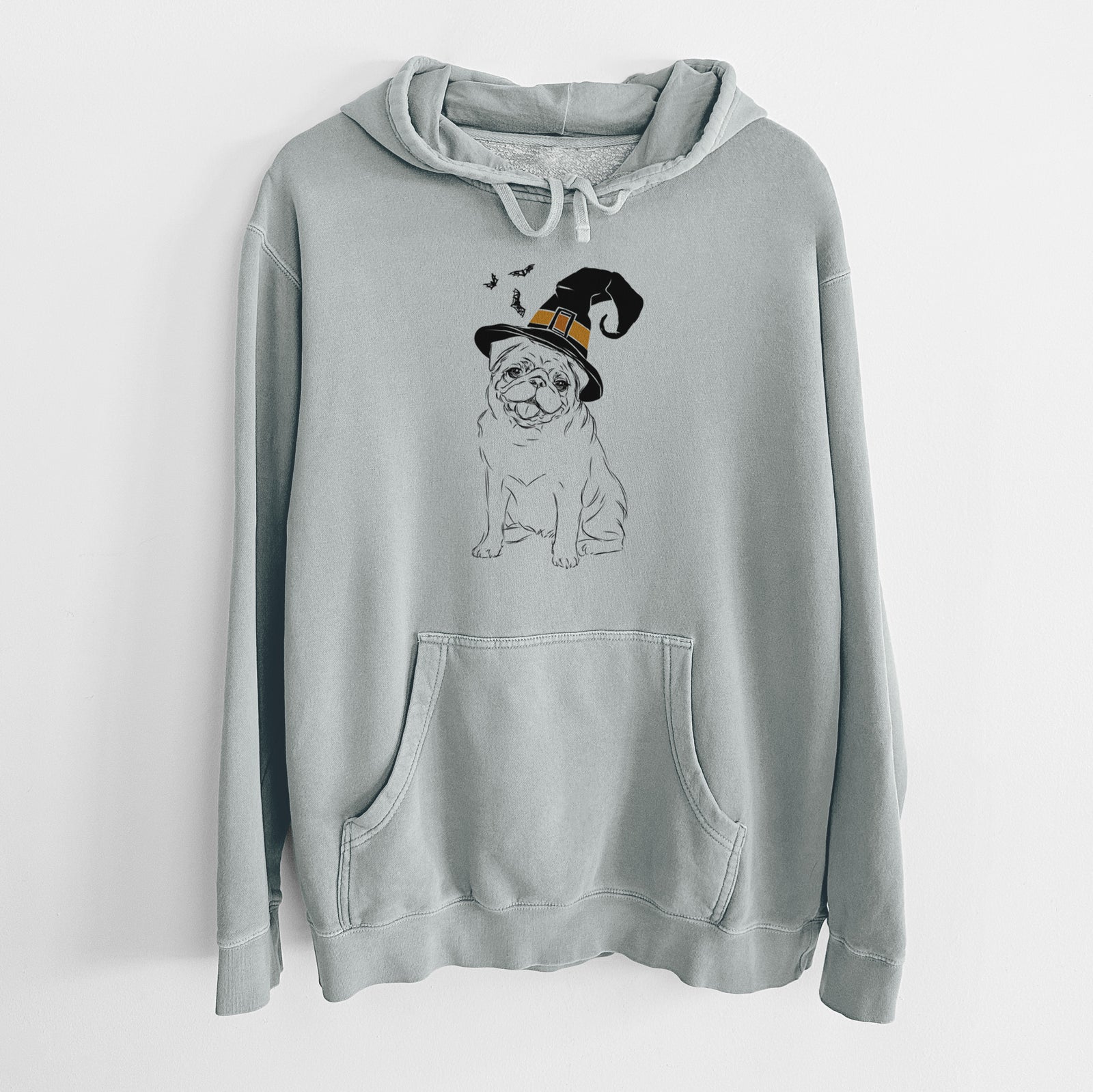 Hand-drawn sketch of Higgins the Pug wearing a witch hat on a Sage Unisex pigment dyed hoodie