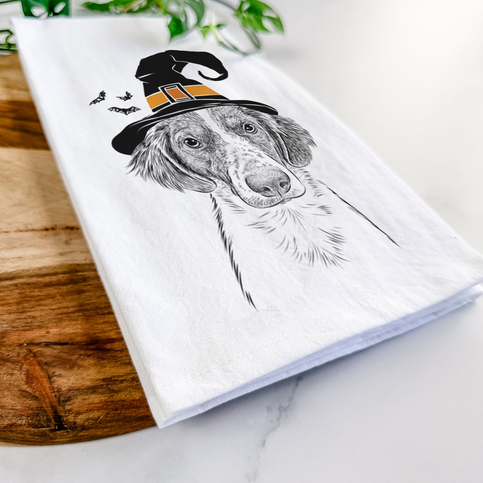 Hand-drawn sketch of Holly the Brittany Spaniel wearing a witch hat on a tea towel