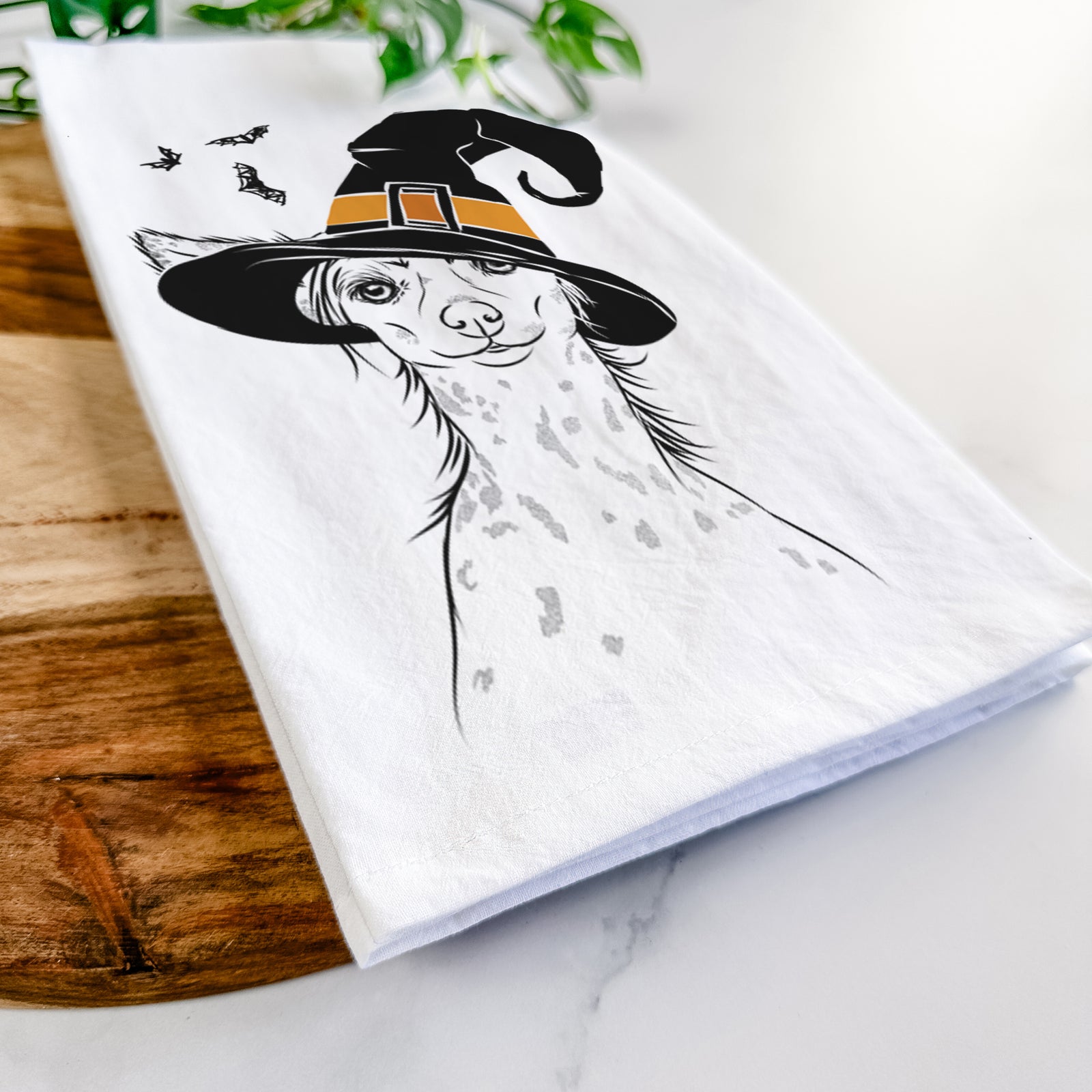 Hand-drawn sketch of Hudson the Chinese Crested wearing a witch hat on a tea towel