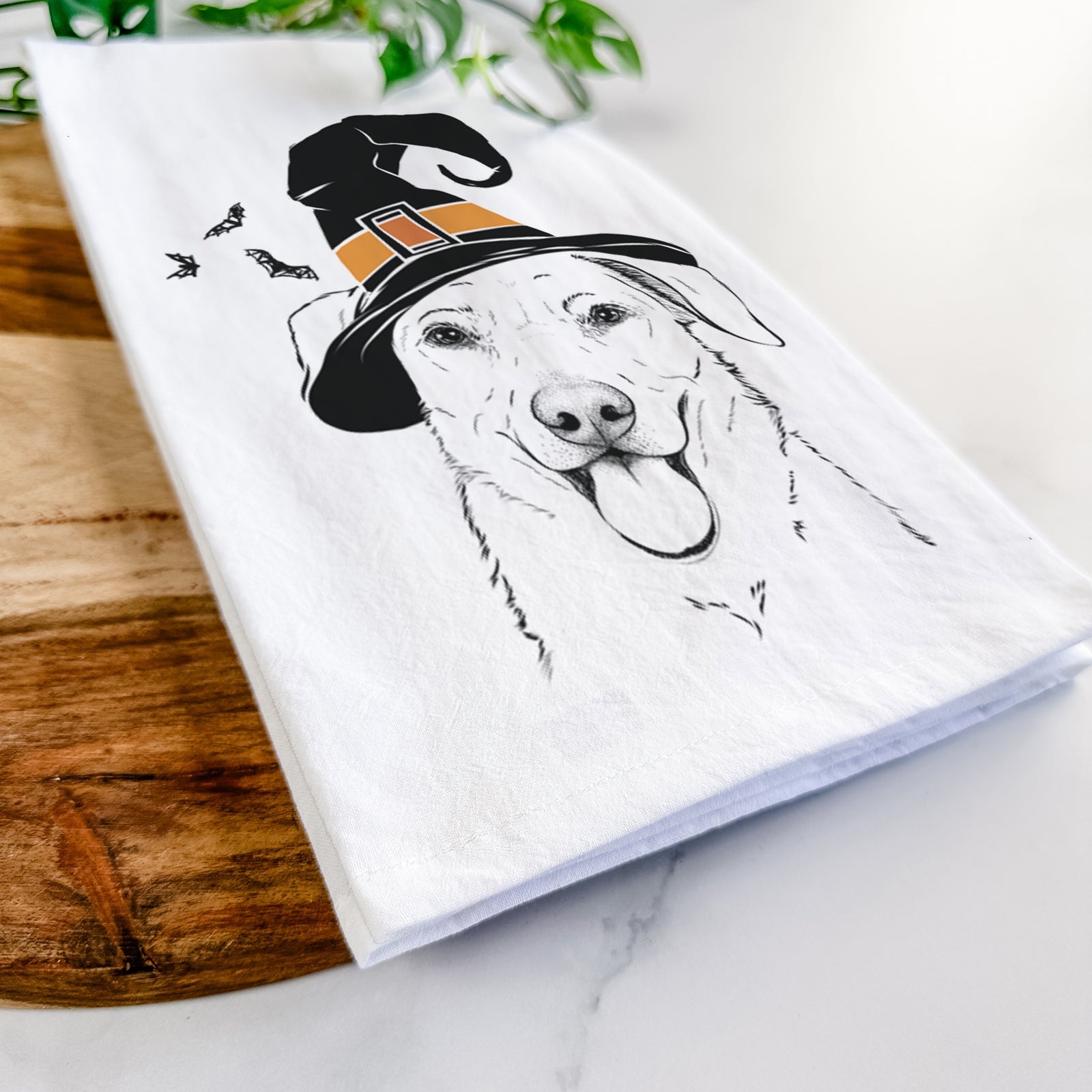 Hand-drawn sketch of Hudson the Shepherd wearing a witch hat on a tea towel