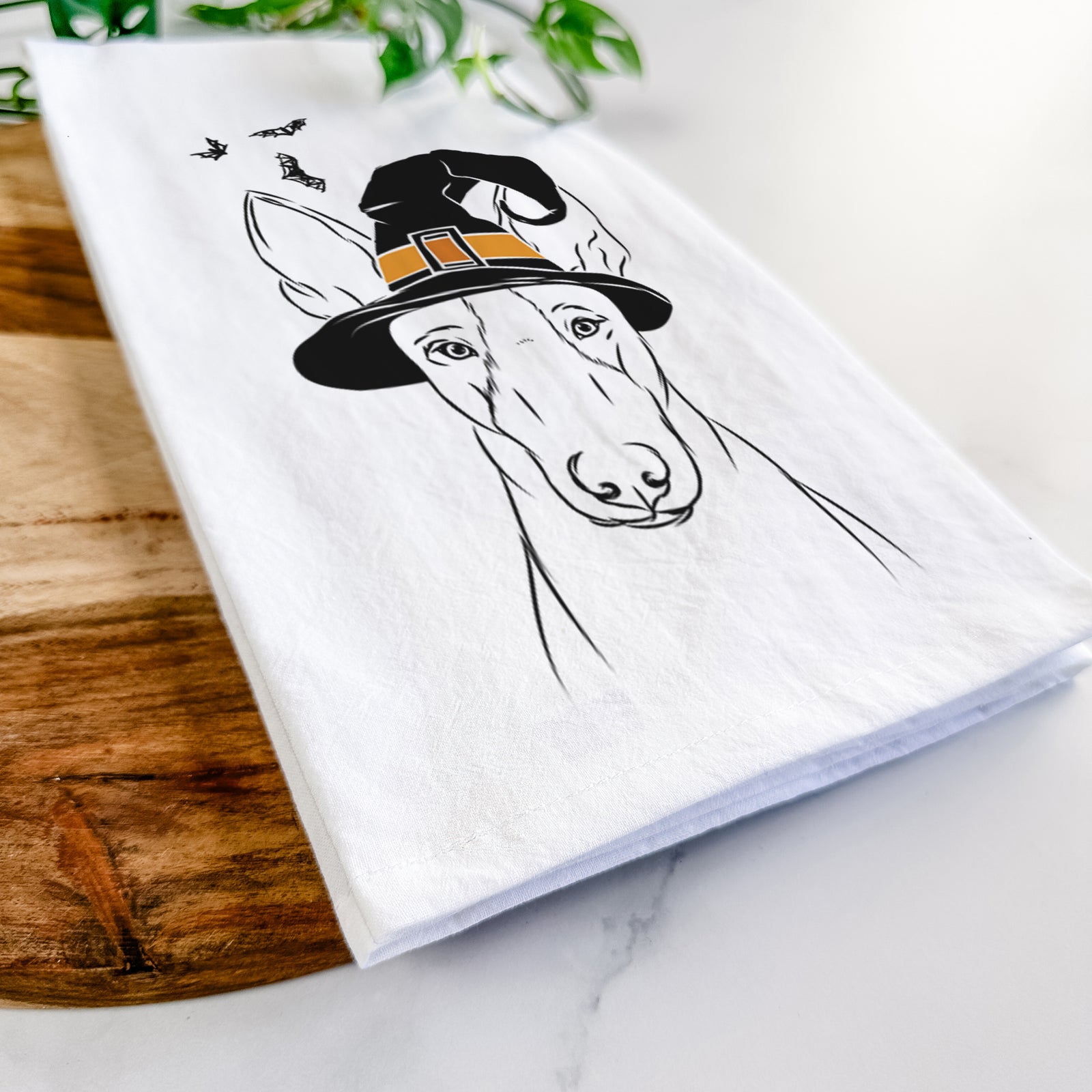 Hand-drawn sketch of Indy the Ibizan Hound wearing a witch hat on a tea towel