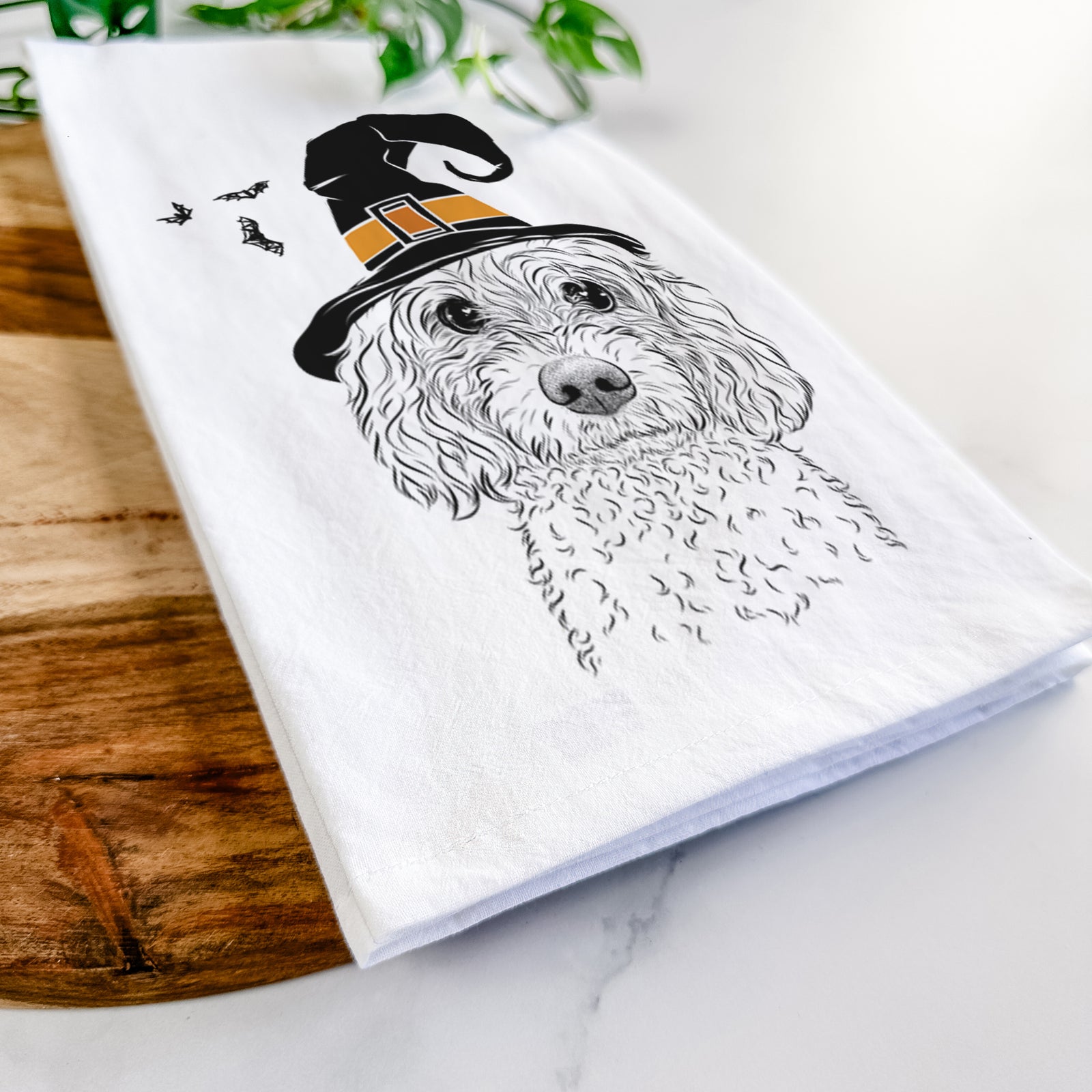 Hand-drawn sketch of Izzie the Cavachon wearing a witch hat on a tea towel