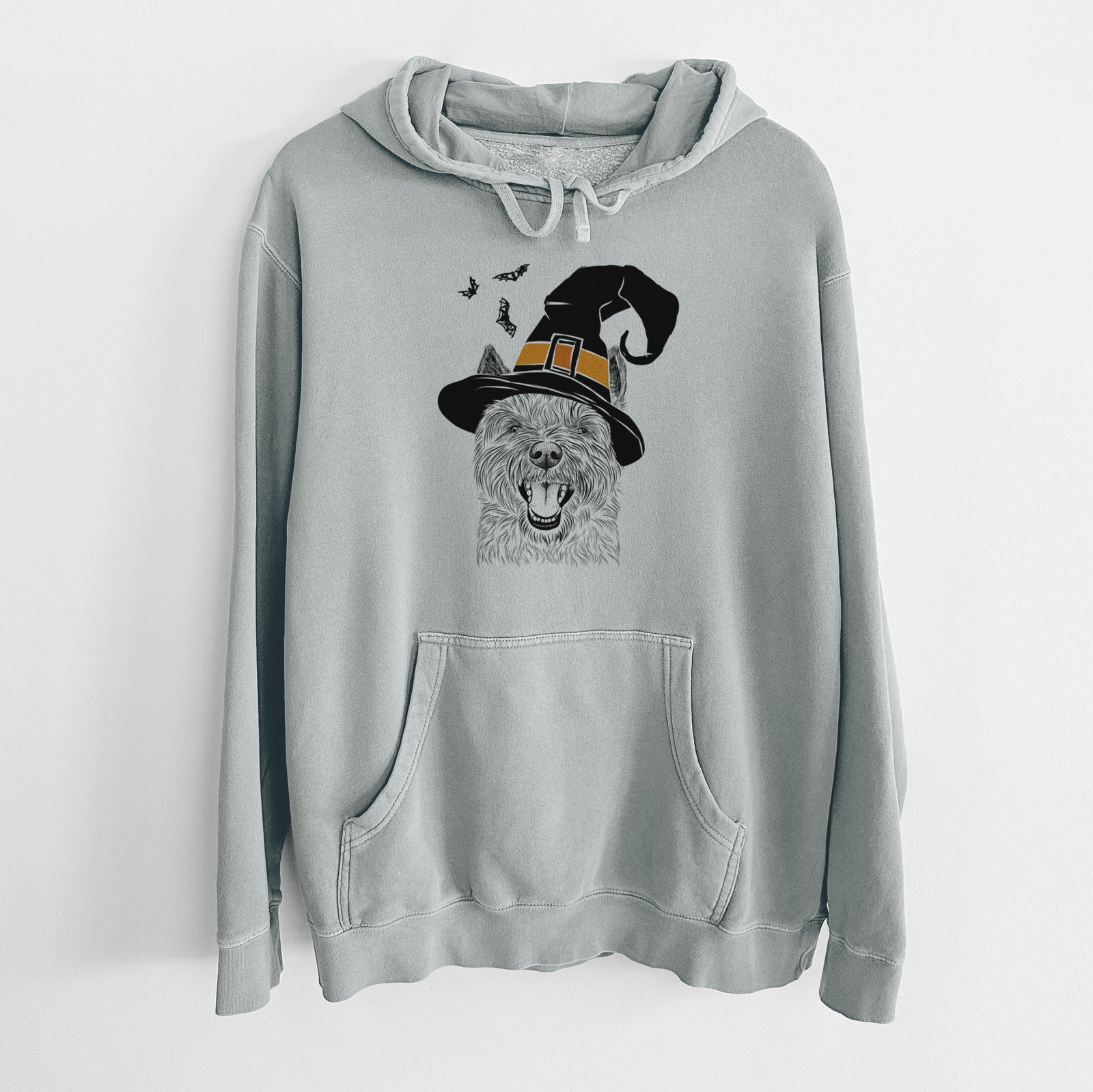Hand-drawn sketch of Jeff the Cairn Terrier wearing a witch hat on a Sage Unisex pigment dyed hoodie
