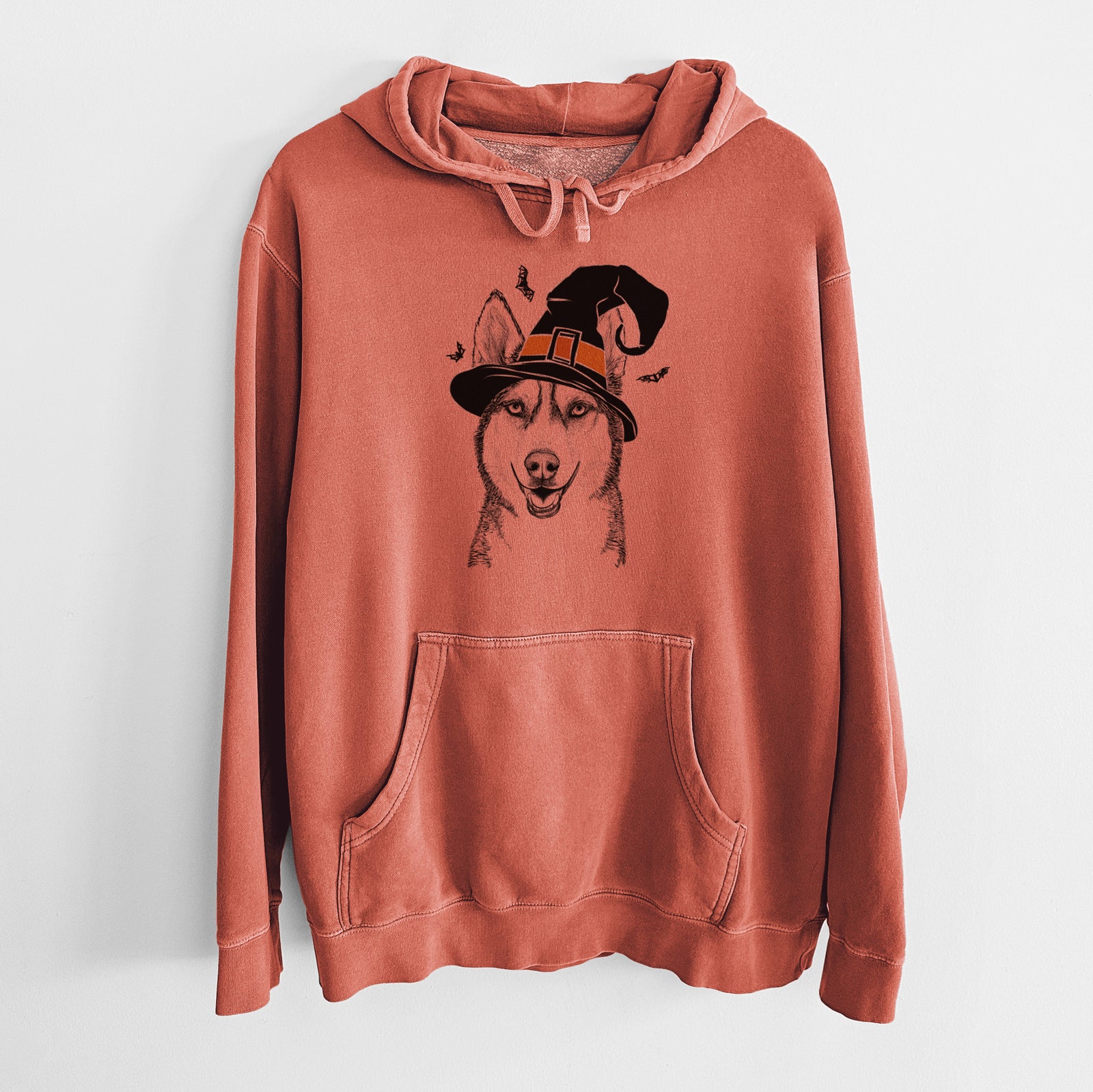 Hand-drawn sketch of Kira the Siberian Husky wearing a witch hat on an Amber Unisex pigment dyed hoodie