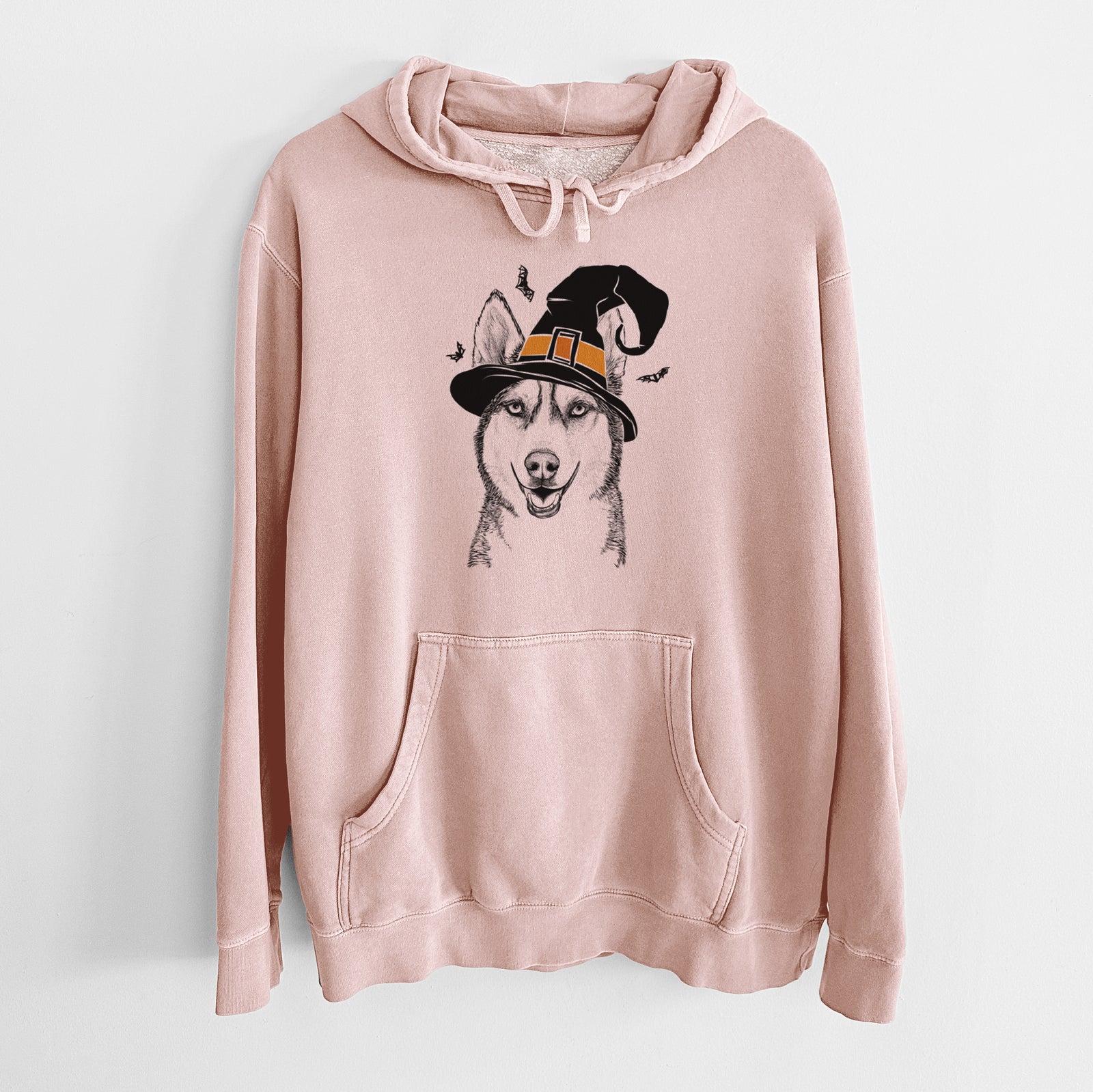 Hand-drawn sketch of Kira the Siberian Husky wearing a witch hat on a Dusty Pink Unisex pigment dyed hoodie