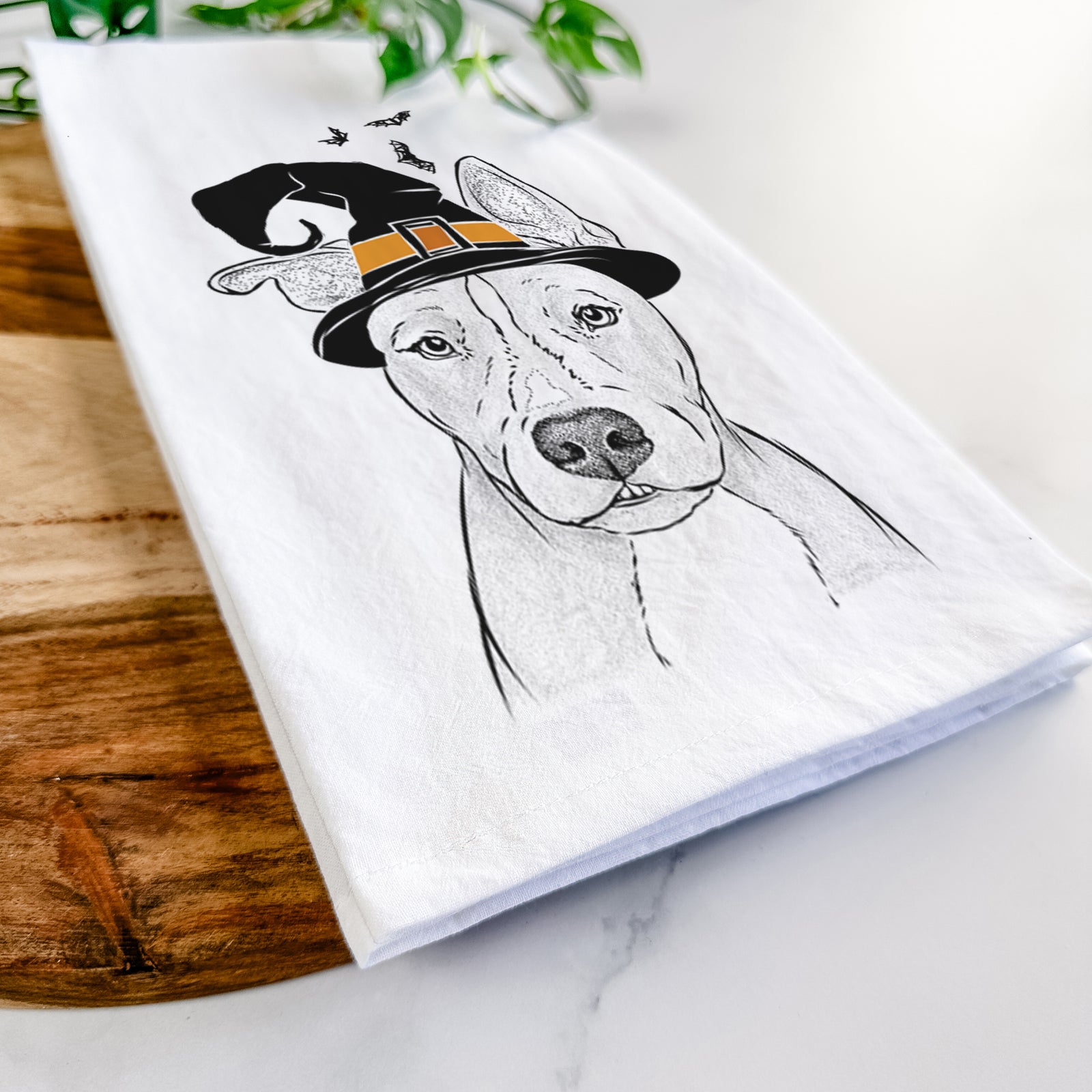 Hand-drawn sketch of Kisses the Pitbull wearing a witch hat on a tea towel