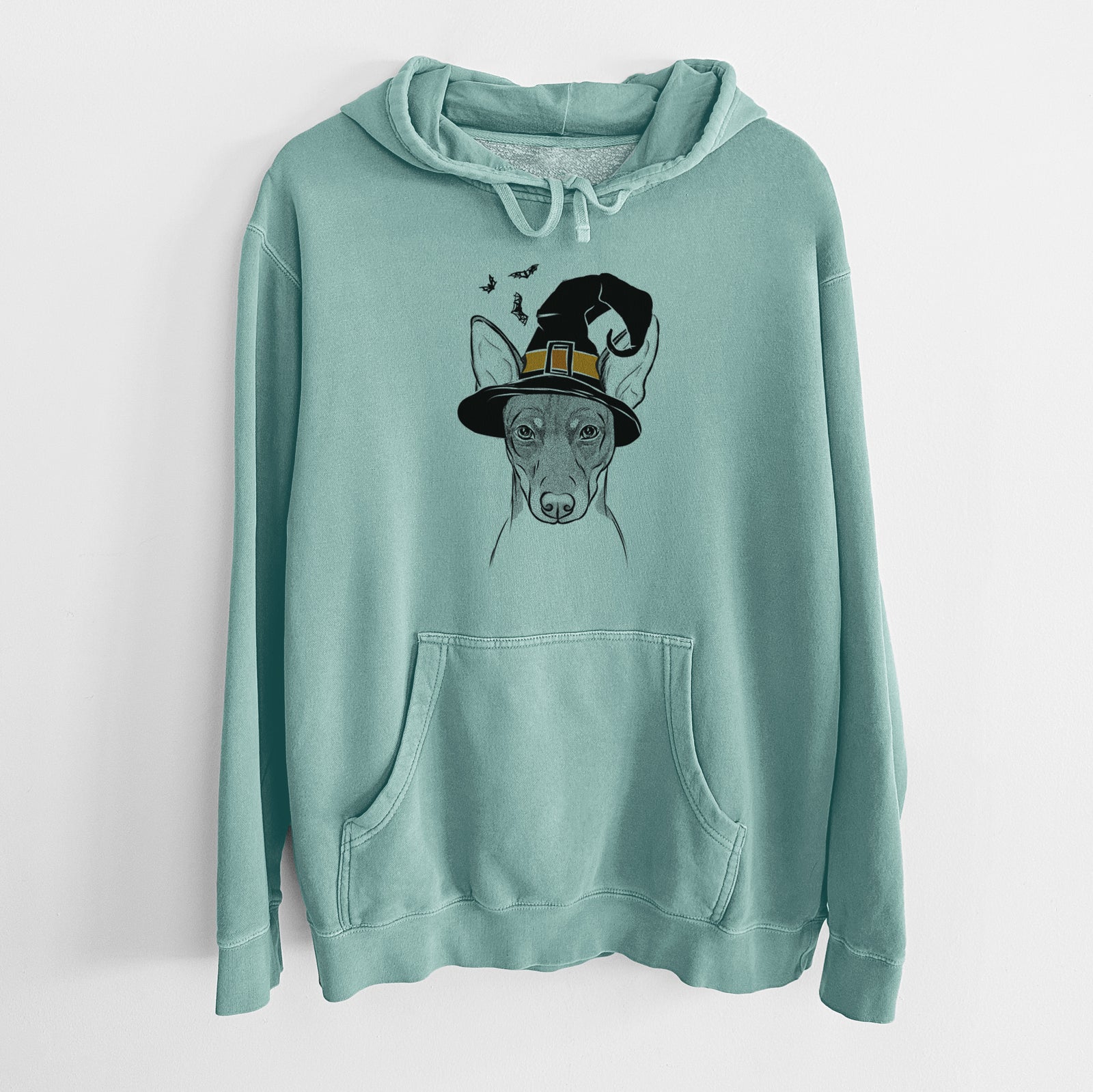 Hand-drawn sketch of Knox the Rat Terrier wearing a witch hat on a Mint Unisex pigment dyed hoodie