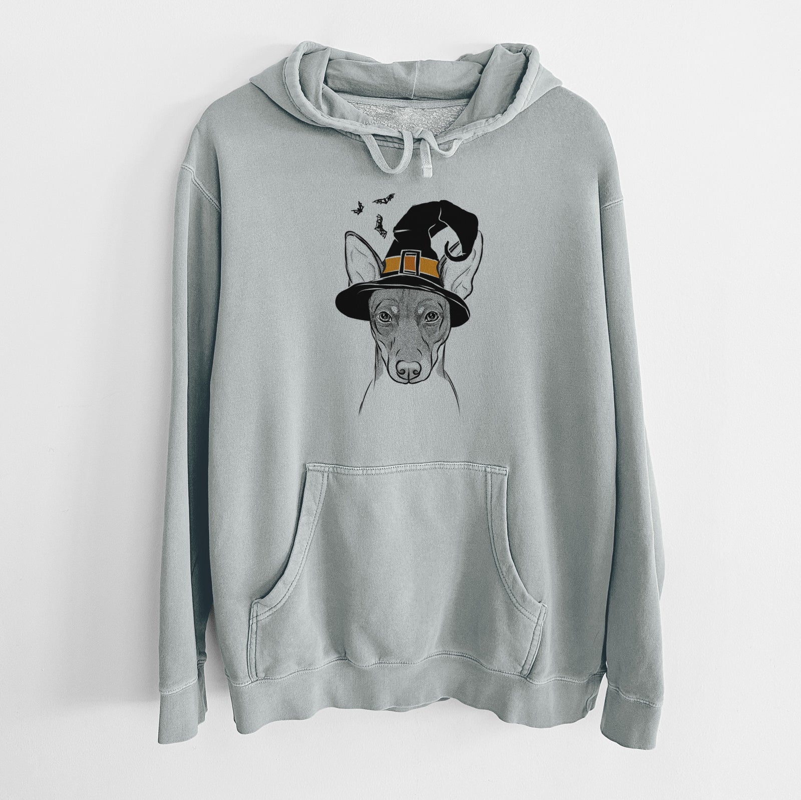 Hand-drawn sketch of Knox the Rat Terrier wearing a witch hat on a Sage Unisex pigment dyed hoodie