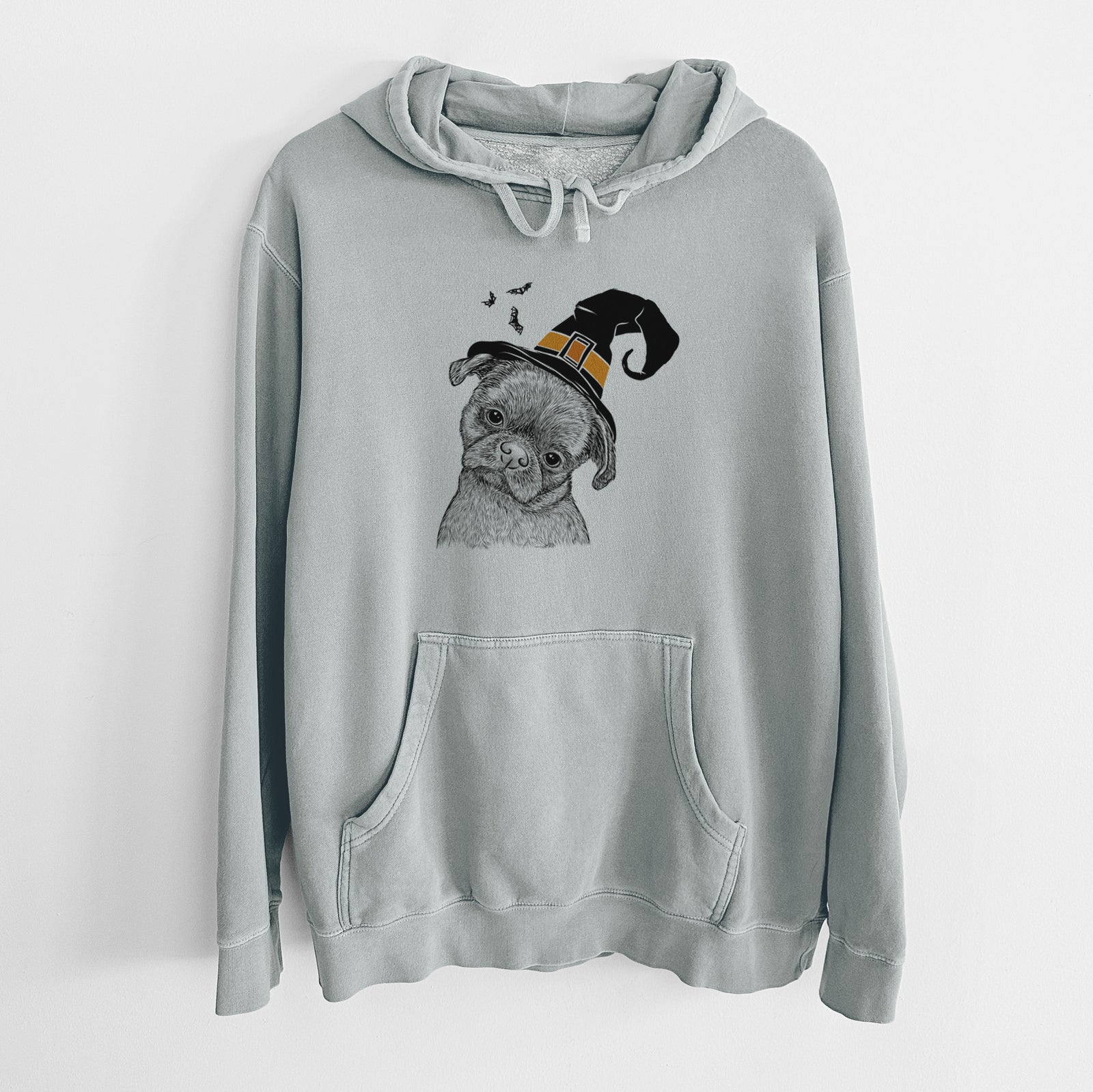 Hand-drawn sketch of Koko the Shih Tzu wearing a witch hat on a Sage Unisex pigment dyed hoodie
