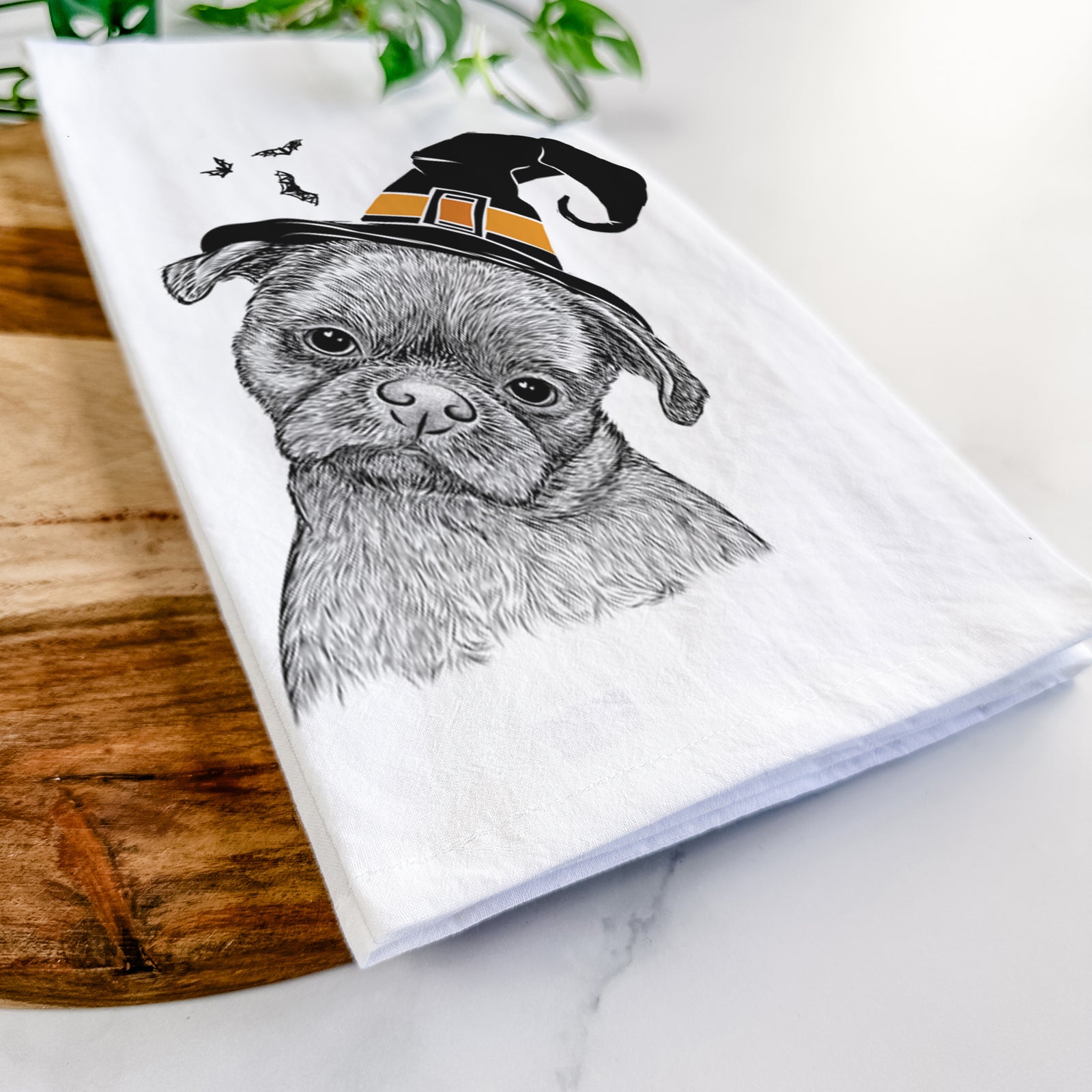 Hand-drawn sketch of Koko the Shih Tzu wearing a witch hat on a tea towel