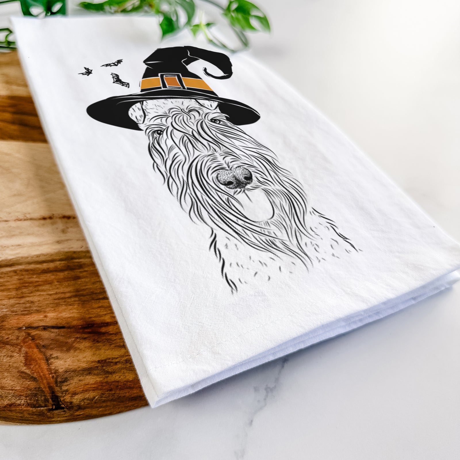 Hand-drawn sketch of Kricket the Kerry Blue Terrier wearing a witch hat on a tea towel