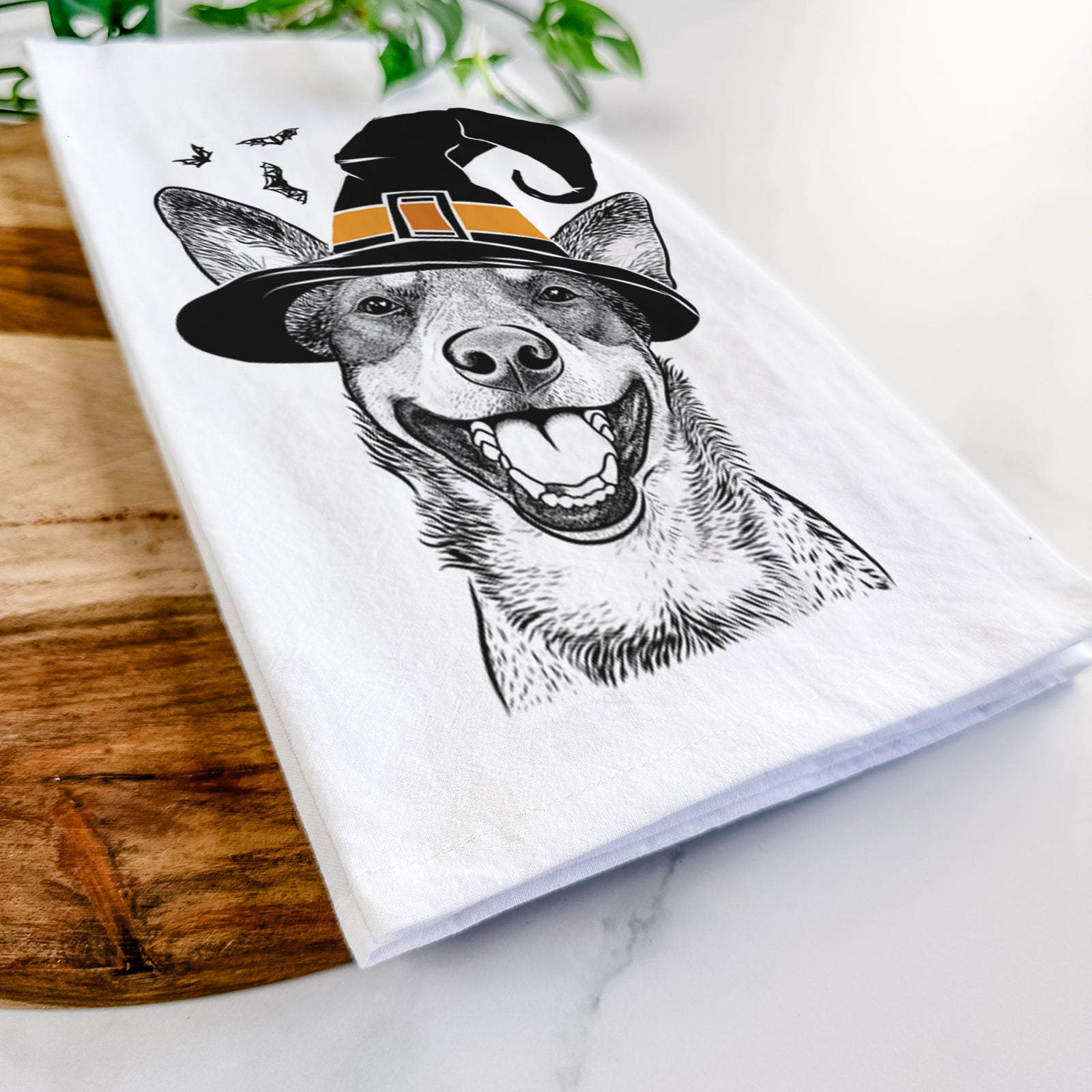 Hand-drawn sketch of Lily the Australian Cattle Dog wearing a witch hat on a tea towel