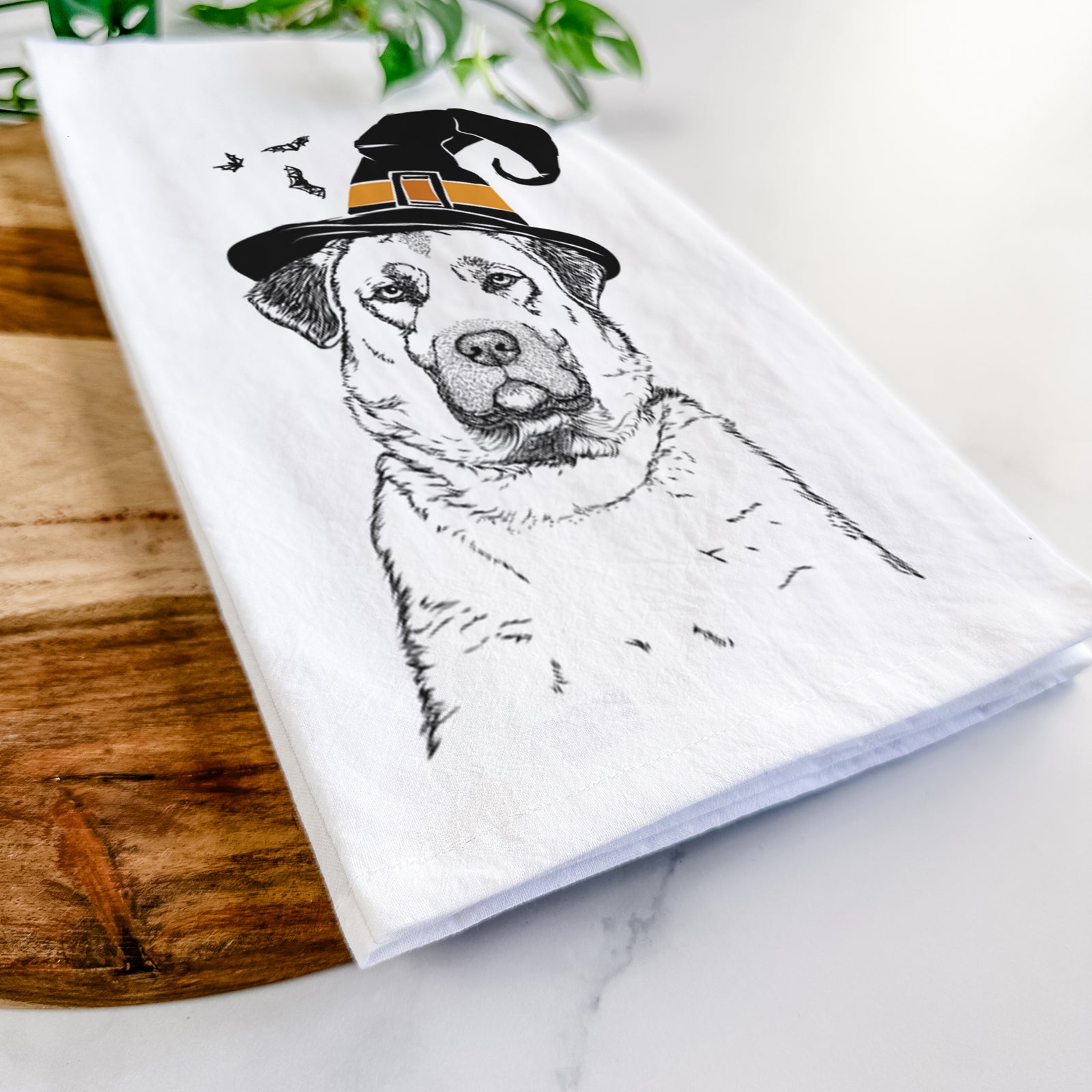 Hand-drawn sketch of Loca the Anatolian Shepherd wearing a witch hat on a tea towel