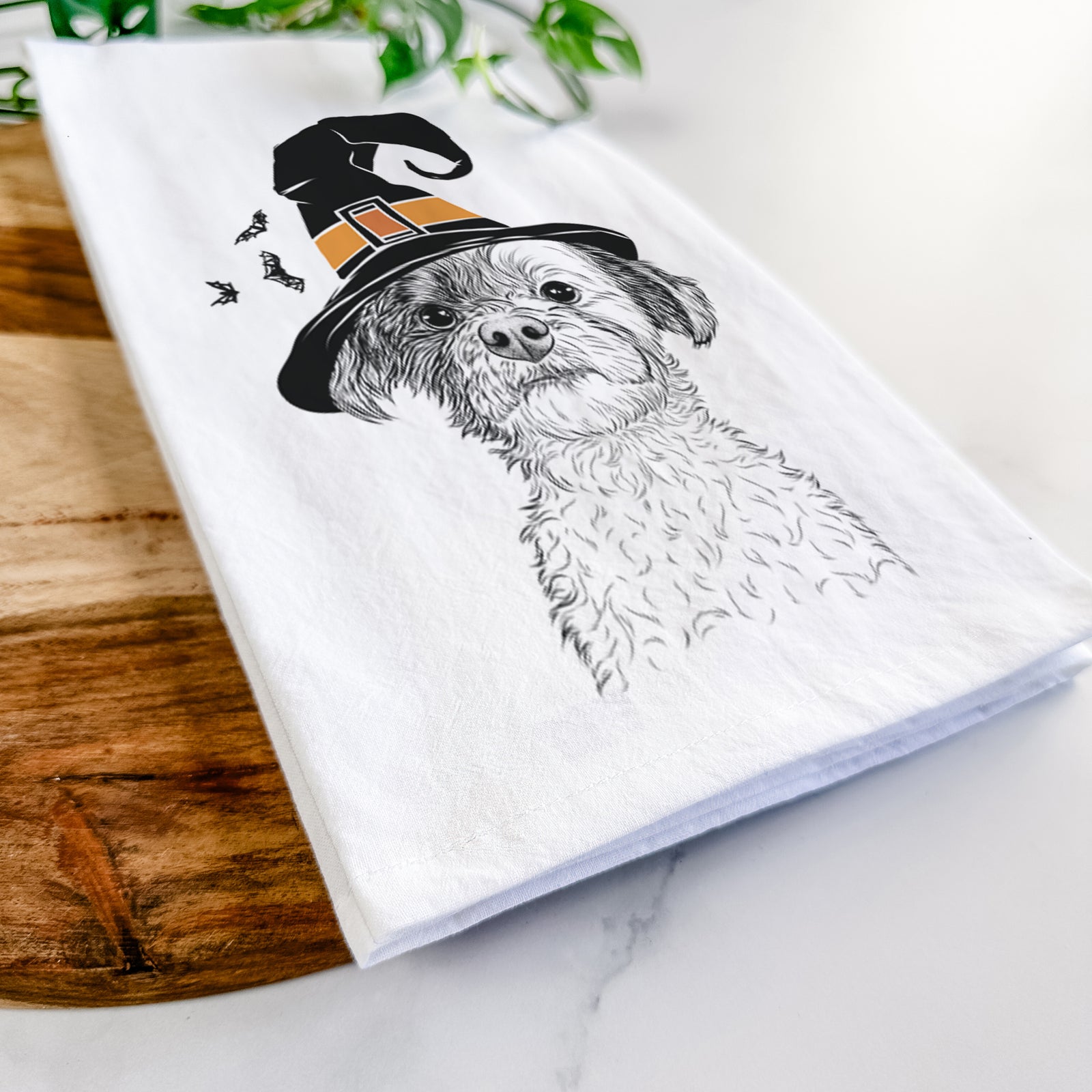 Hand-drawn sketch of Louise the Havanese wearing a witch hat on a tea towel