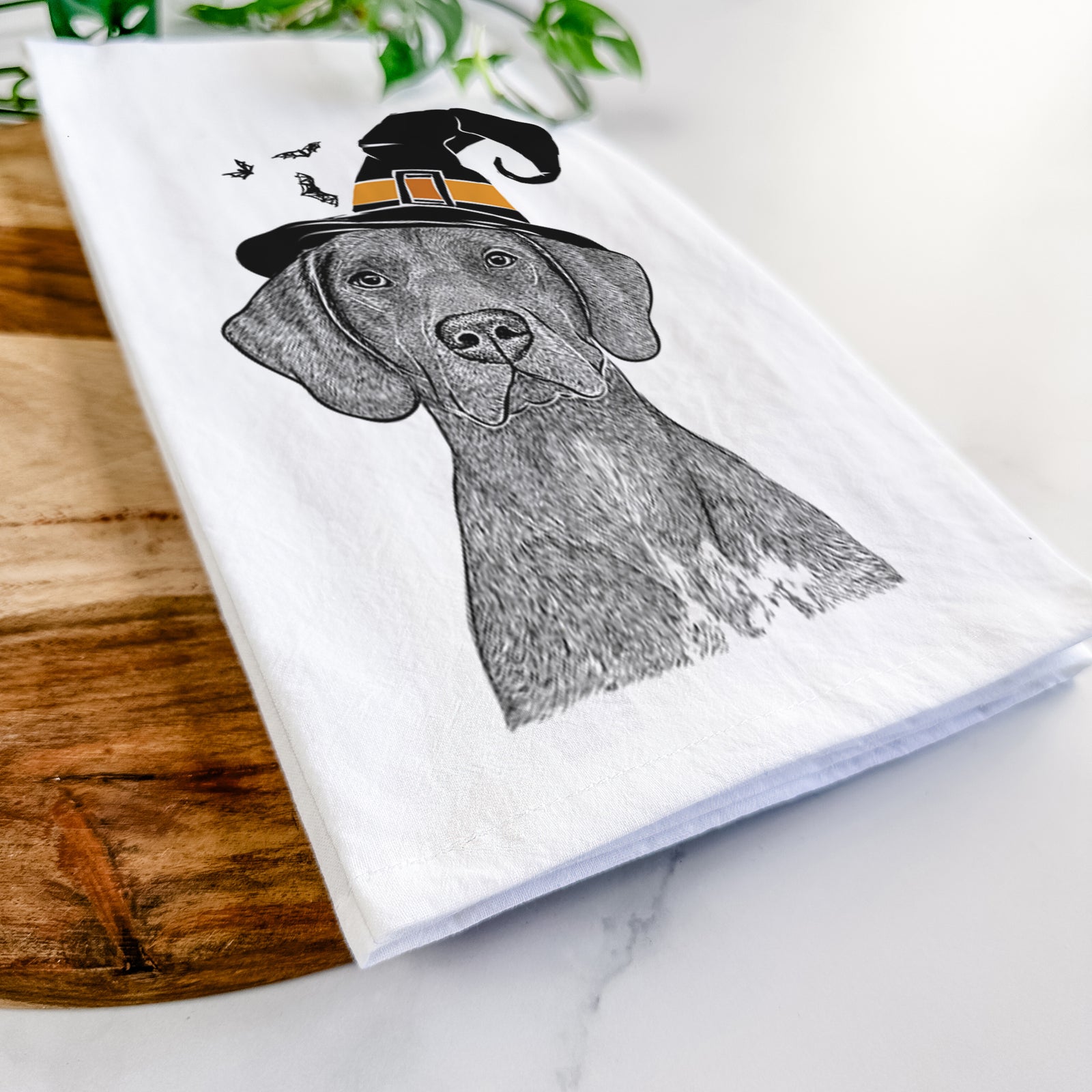 Hand-drawn sketch of Lucifer the German Shorthaired Pointer wearing a witch hat on a tea towel