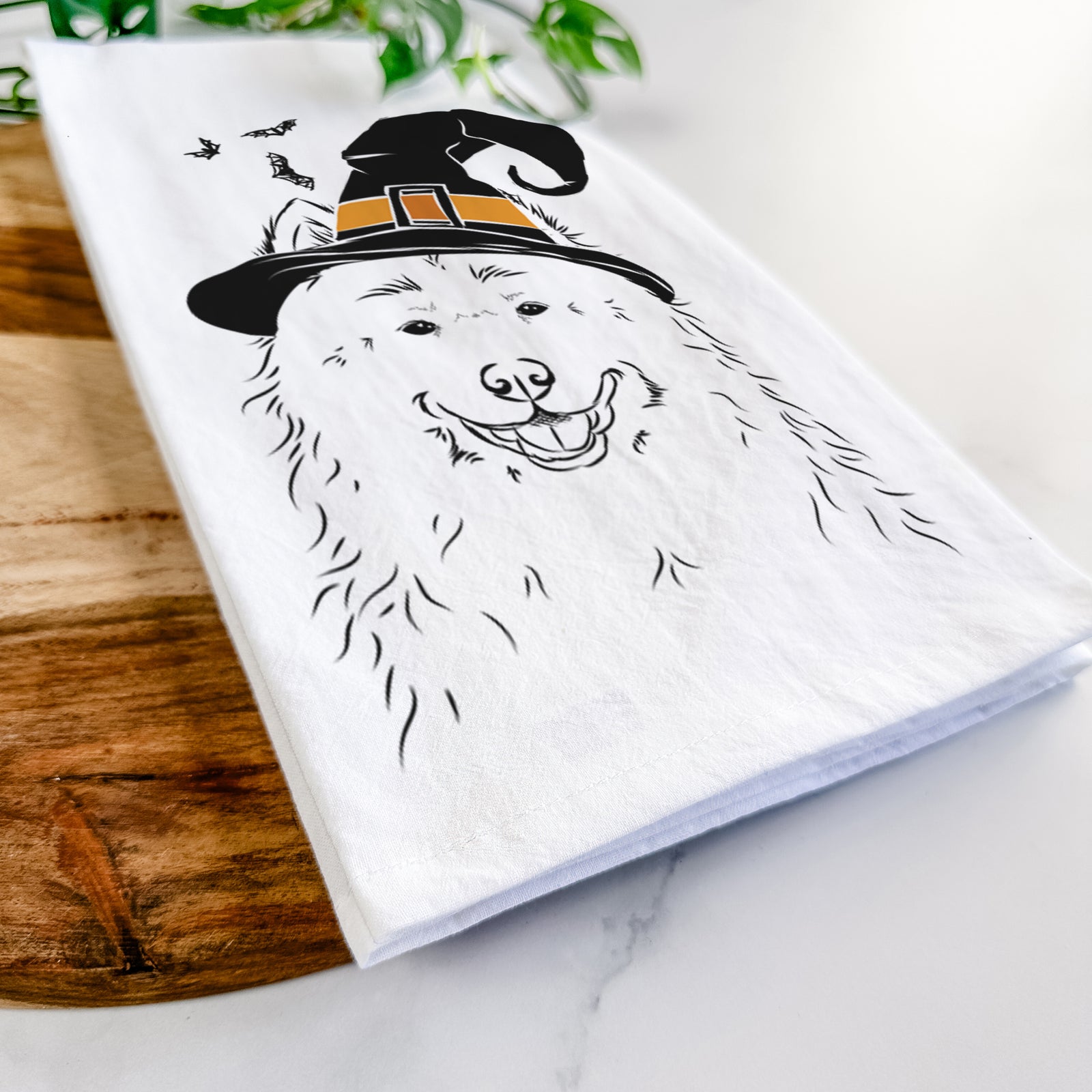 Hand-drawn sketch of Luka the Samoyed wearing a witch hat on a tea towel