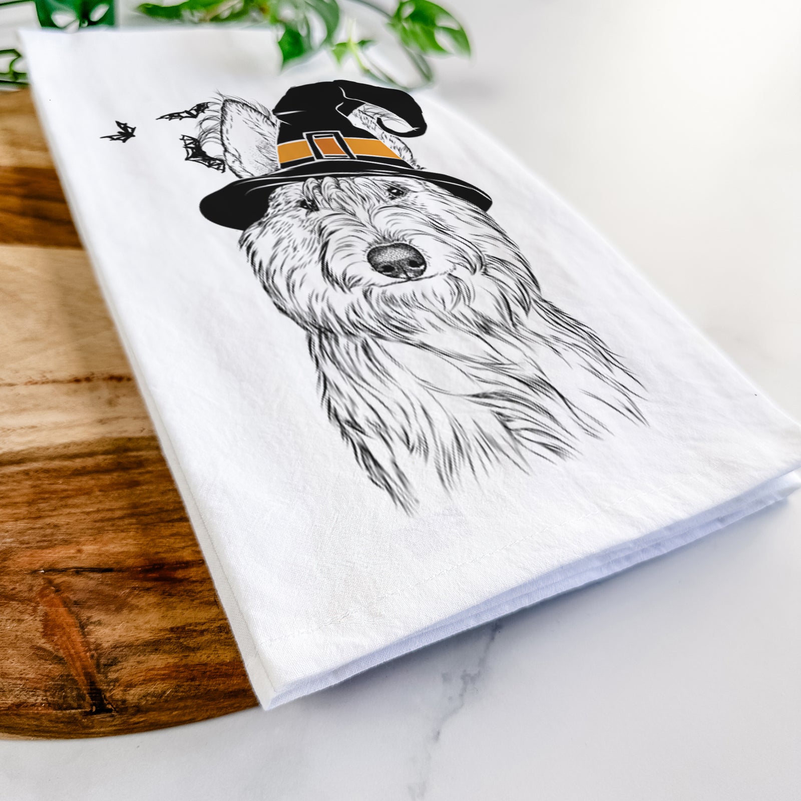 Hand-drawn sketch of Luna the Berger Picard wearing a witch hat on a tea towel