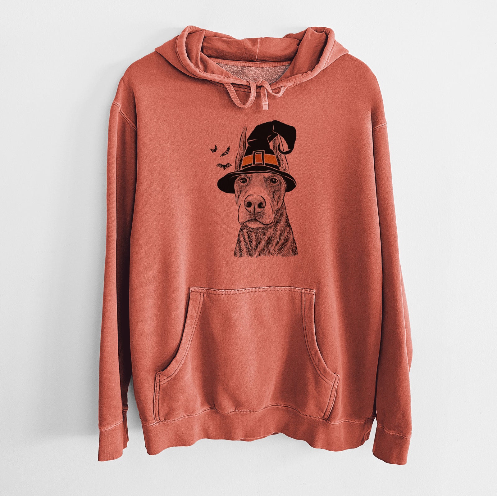 Hand-drawn sketch of Luna the Doberman Pinscher wearing a witch hat on an Amber Unisex pigment dyed hoodie