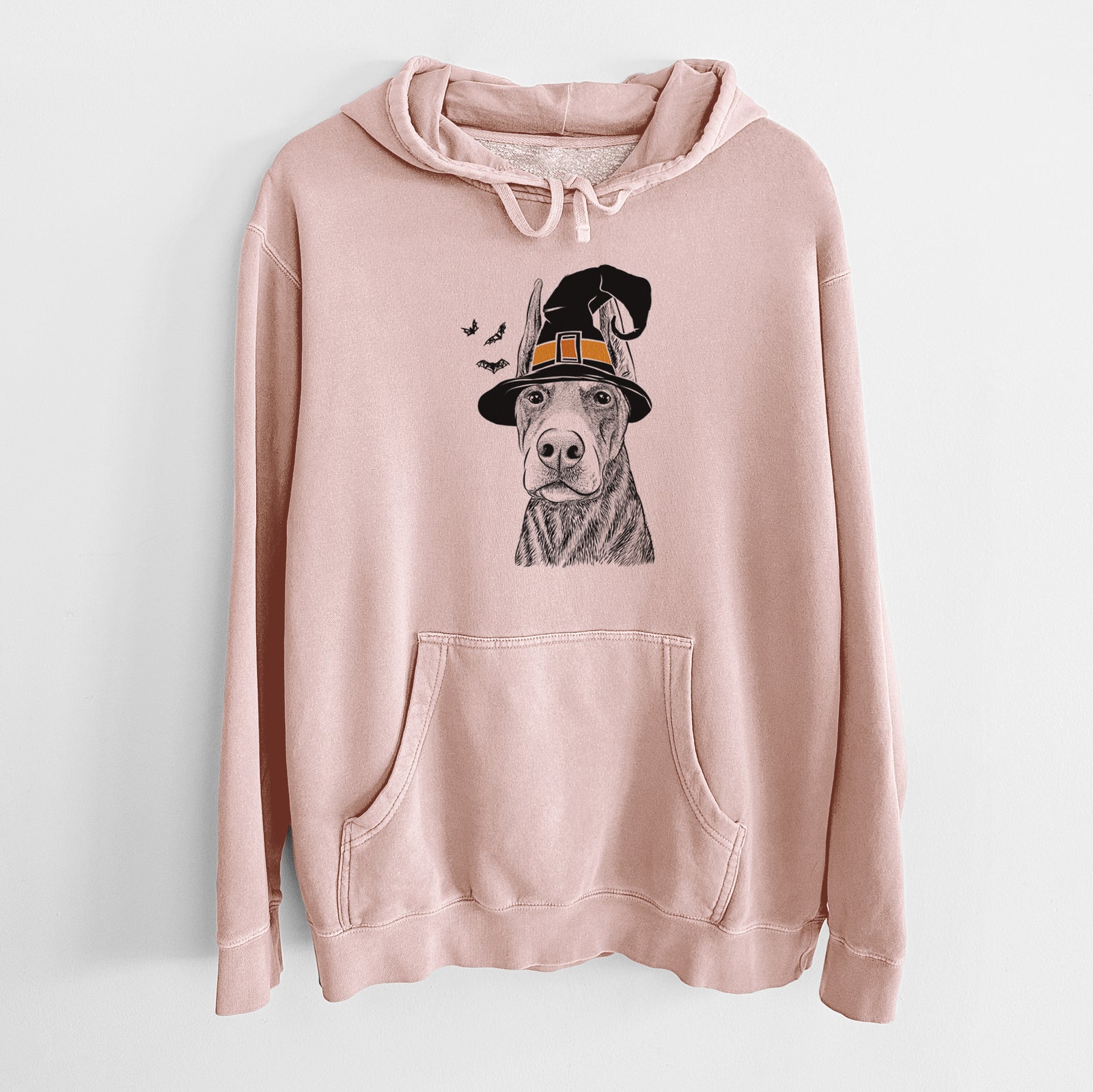 Hand-drawn sketch of Luna the Doberman Pinscher wearing a witch hat on a Dusty Pink Unisex pigment dyed hoodie