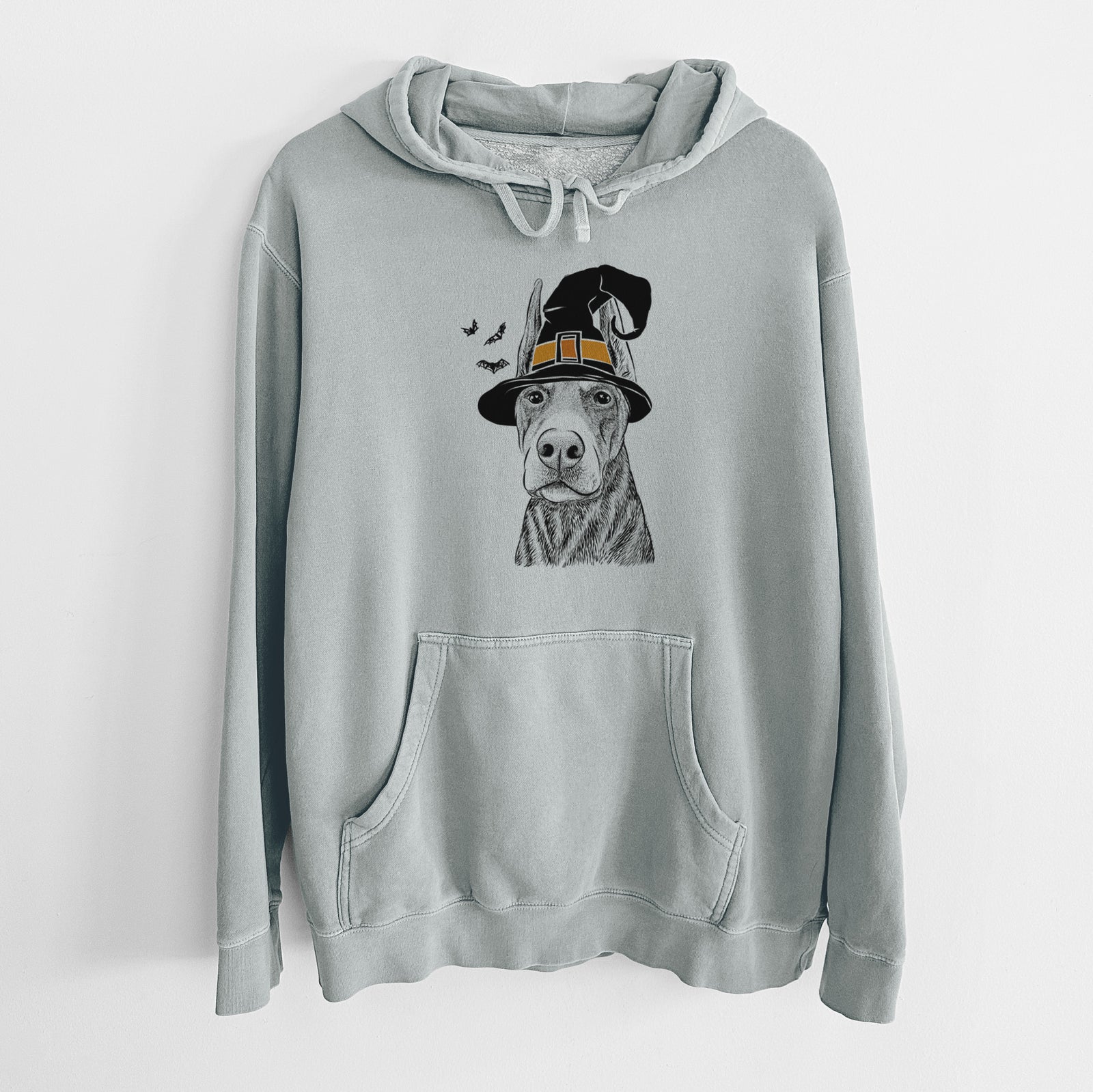 Hand-drawn sketch of Luna the Doberman Pinscher wearing a witch hat on a Sage Unisex pigment dyed hoodie