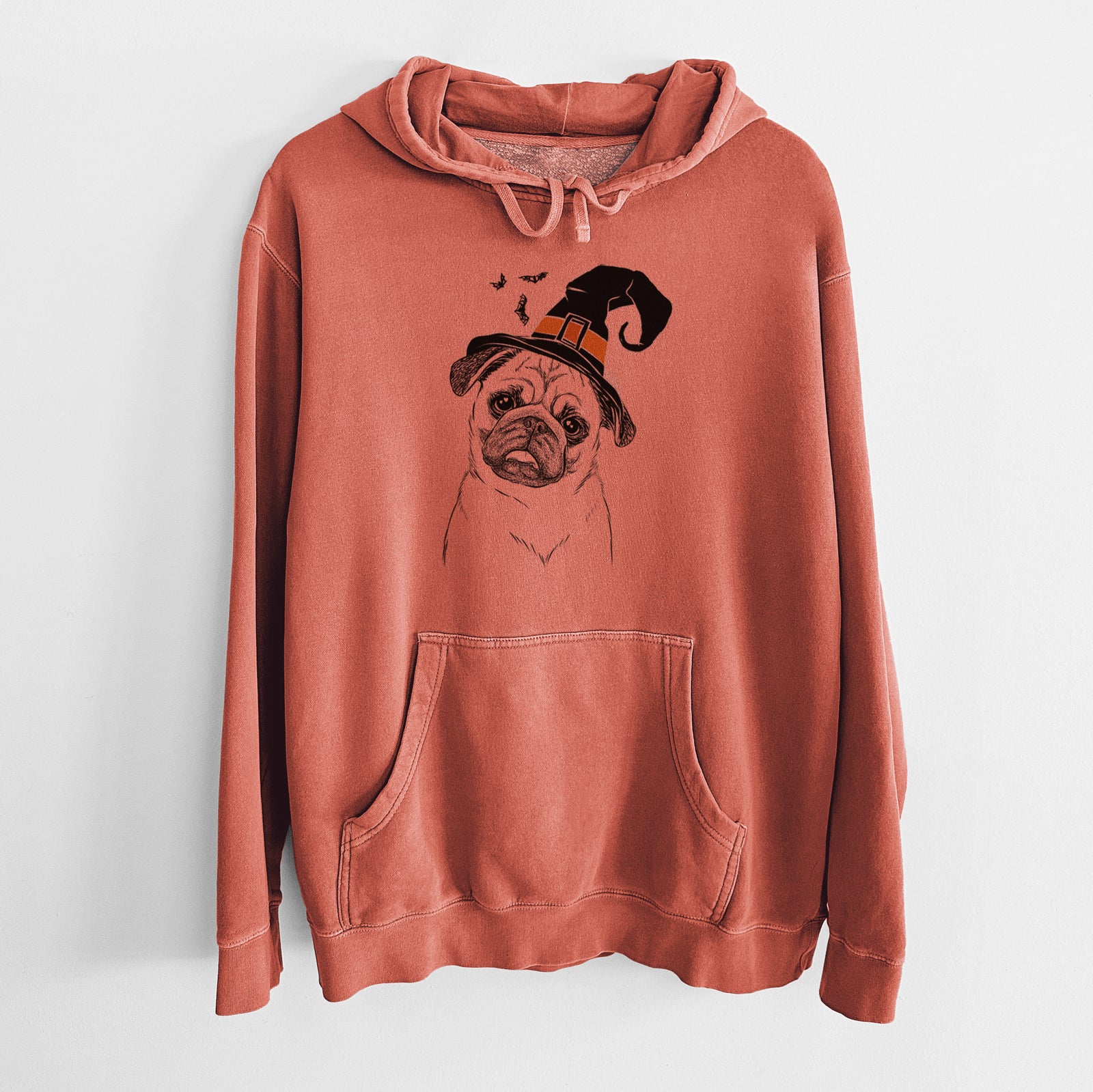 Hand-drawn sketch of Macy the Pug wearing a witch hat on an Amber Unisex pigment dyed hoodie