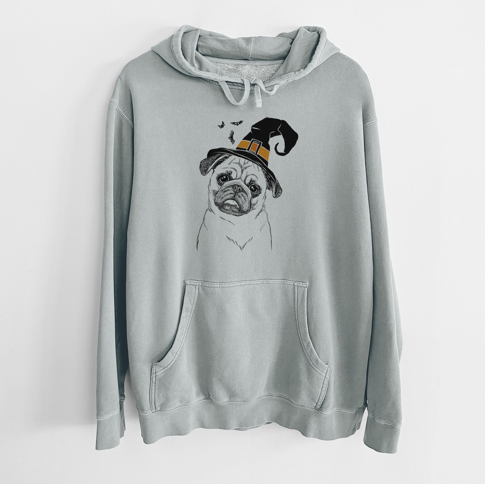 Hand-drawn sketch of Macy the Pug wearing a witch hat on a Sage Unisex pigment dyed hoodie
