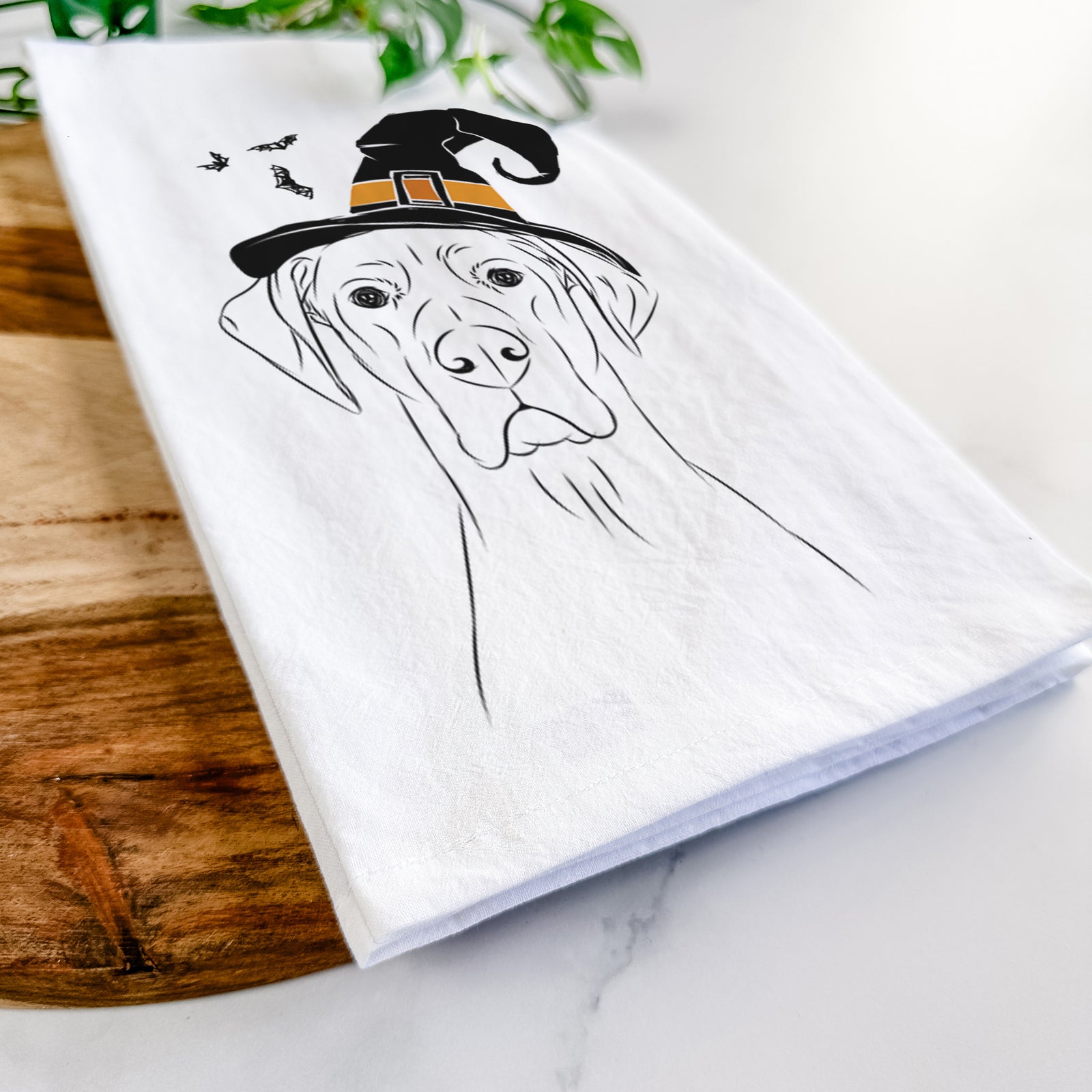 Hand-drawn sketch of Maddox the Great Dane wearing a witch hat on a tea towel