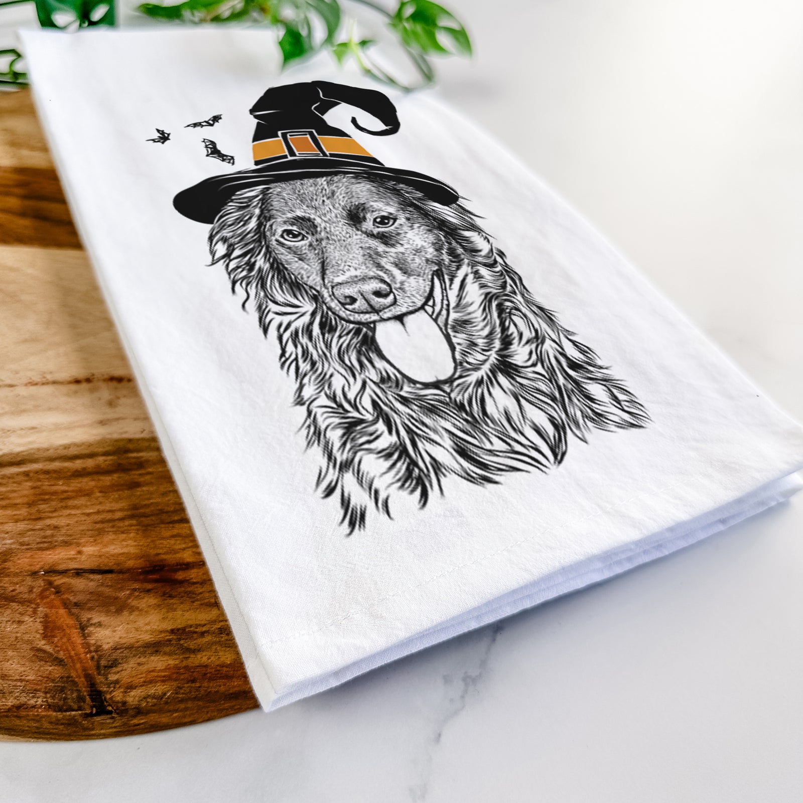 Hand-drawn sketch of Maisie Mae the Aussiedor wearing a witch hat on a tea towel