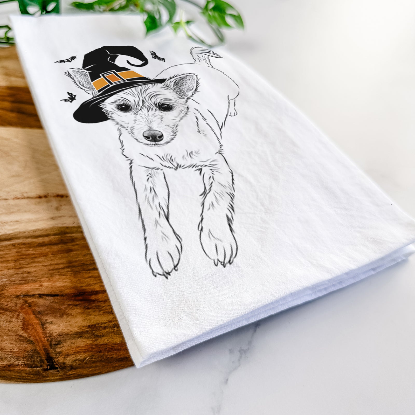 Hand-drawn sketch of Maisie the Terrier Mix wearing a witch hat on a tea towel