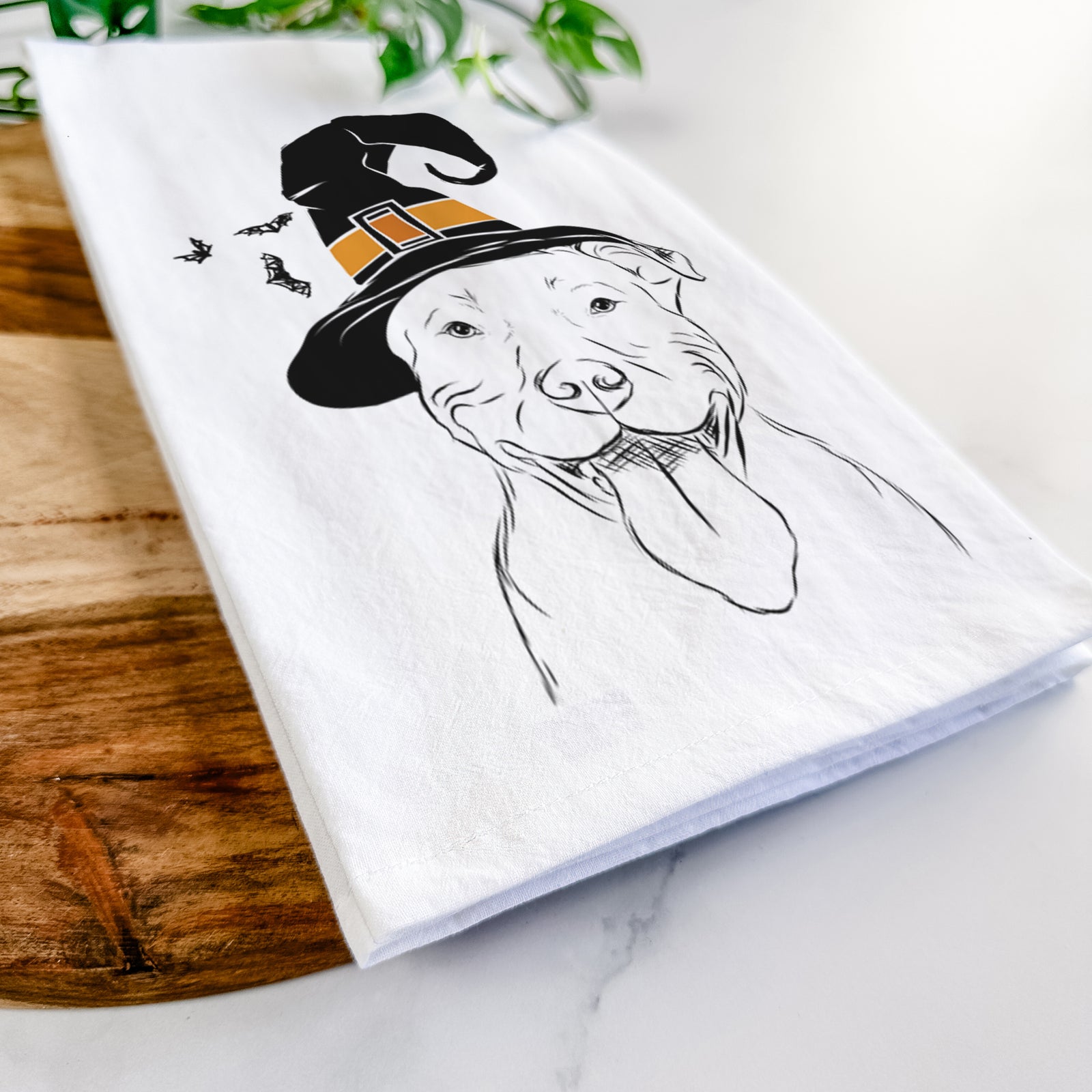 Hand-drawn sketch of Major the Pitbull wearing a witch hat on a tea towel