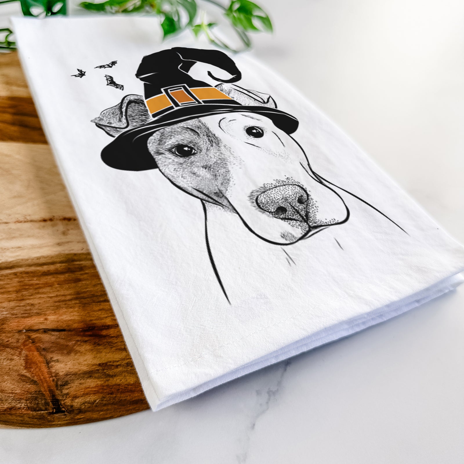 Hand-drawn sketch of Manchi the Pitbull Mix wearing a witch hat on a tea towel