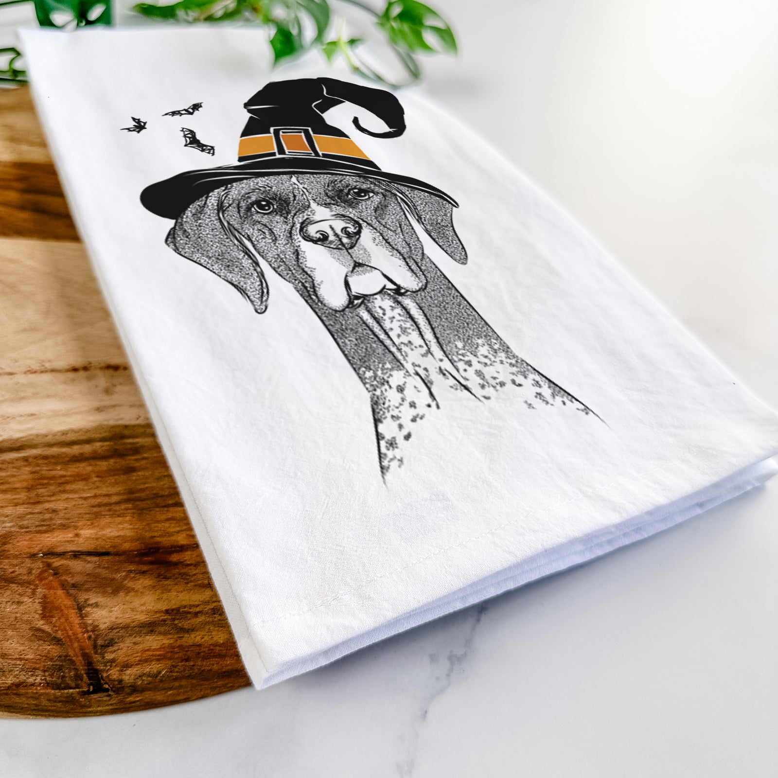 Hand-drawn sketch of Mattis the German Shorthaired Pointer wearing a witch hat on a tea towel