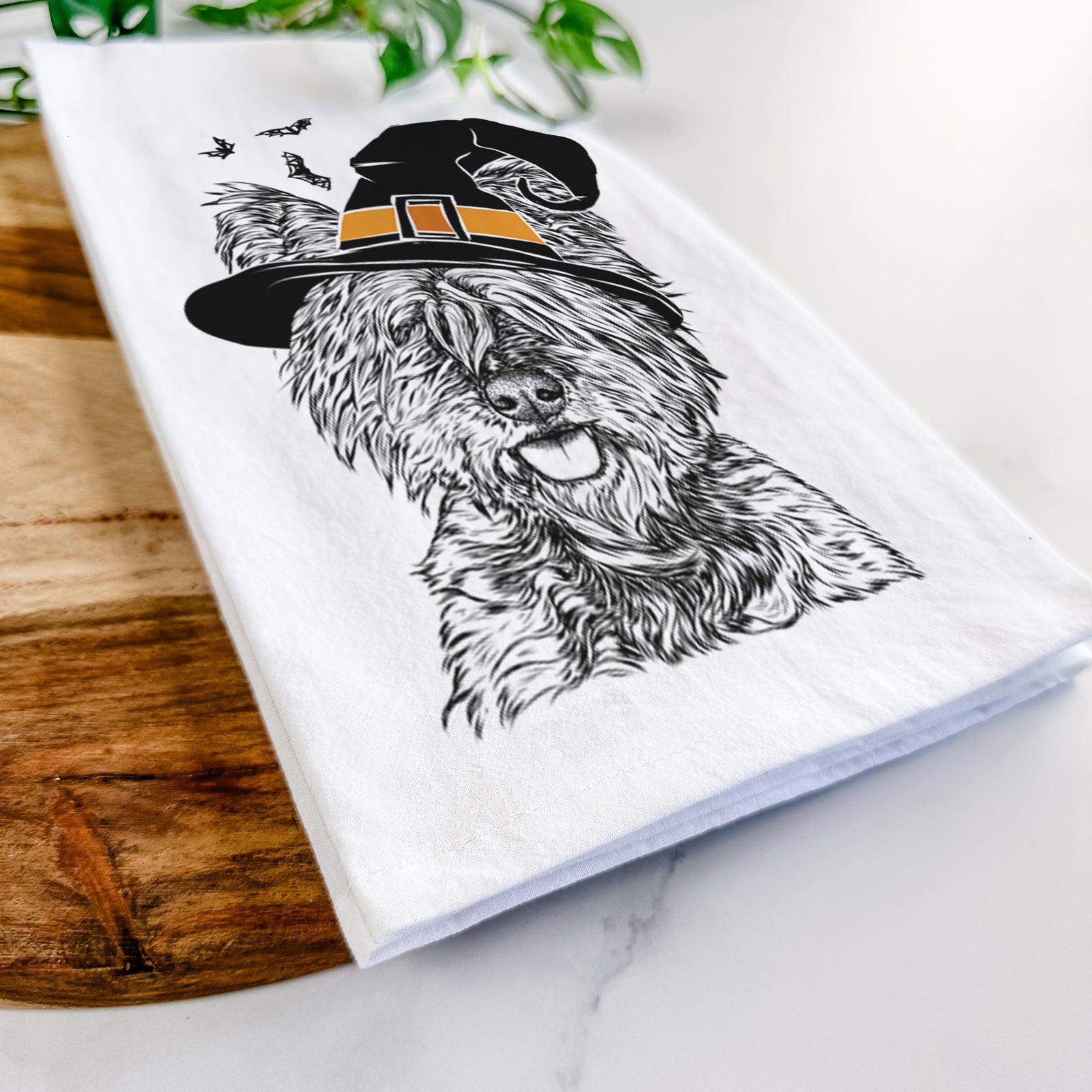Hand-drawn sketch of McDuff the Cairn Terrier wearing a witch hat on a tea towel