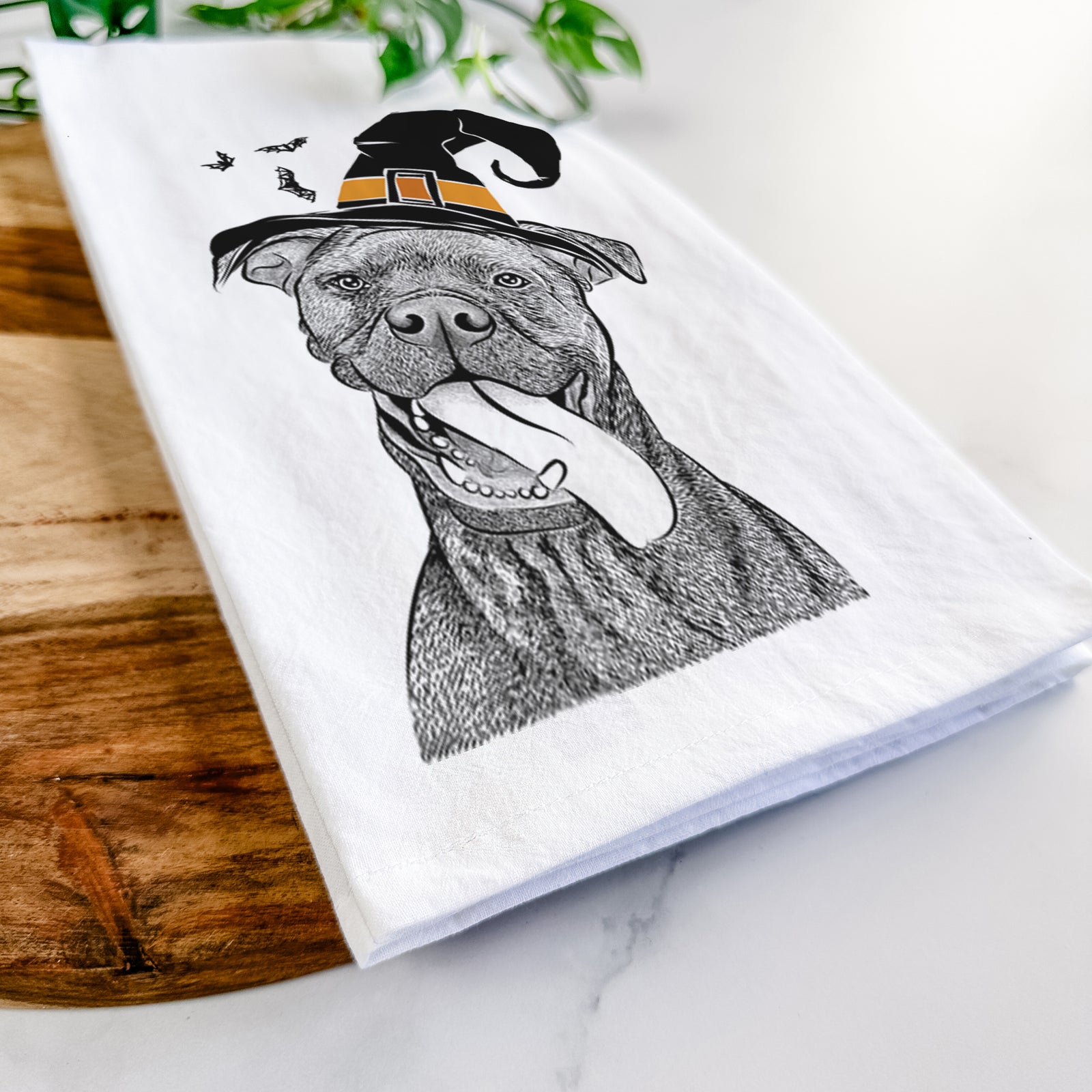 Hand-drawn sketch of Mikey the Boxador wearing a witch hat on a tea towel