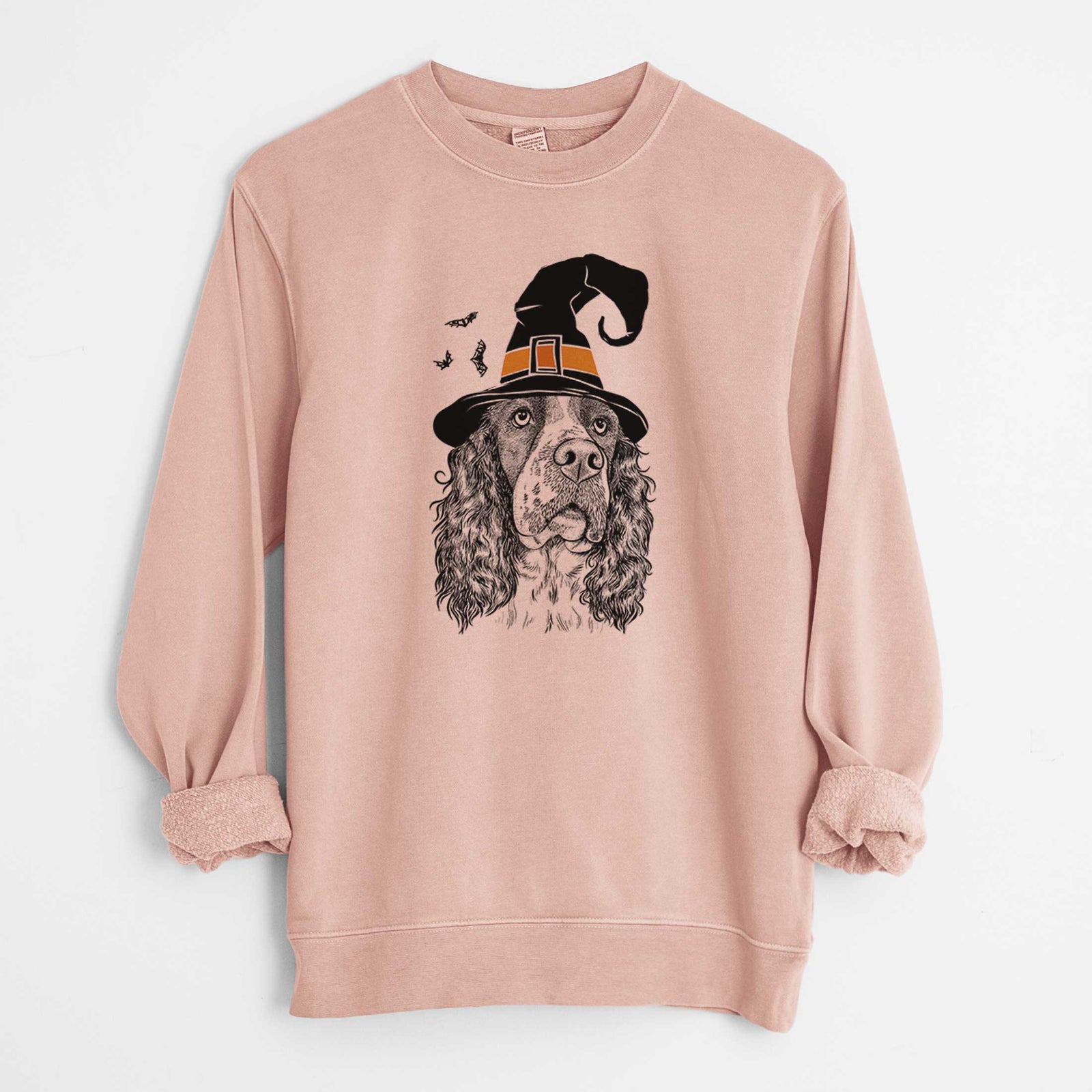 Hand-drawn sketch of Millie Mae the English Springer Spaniel wearing a witch hat on a Dusty Pink Unisex pigment dyed crew sweatshirt