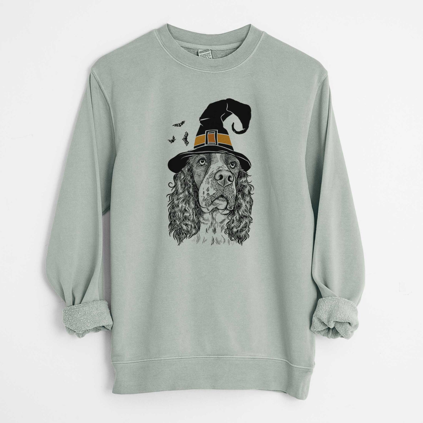 Hand-drawn sketch of Millie Mae the English Springer Spaniel wearing a witch hat on a Sage Unisex pigment dyed crew sweatshirt