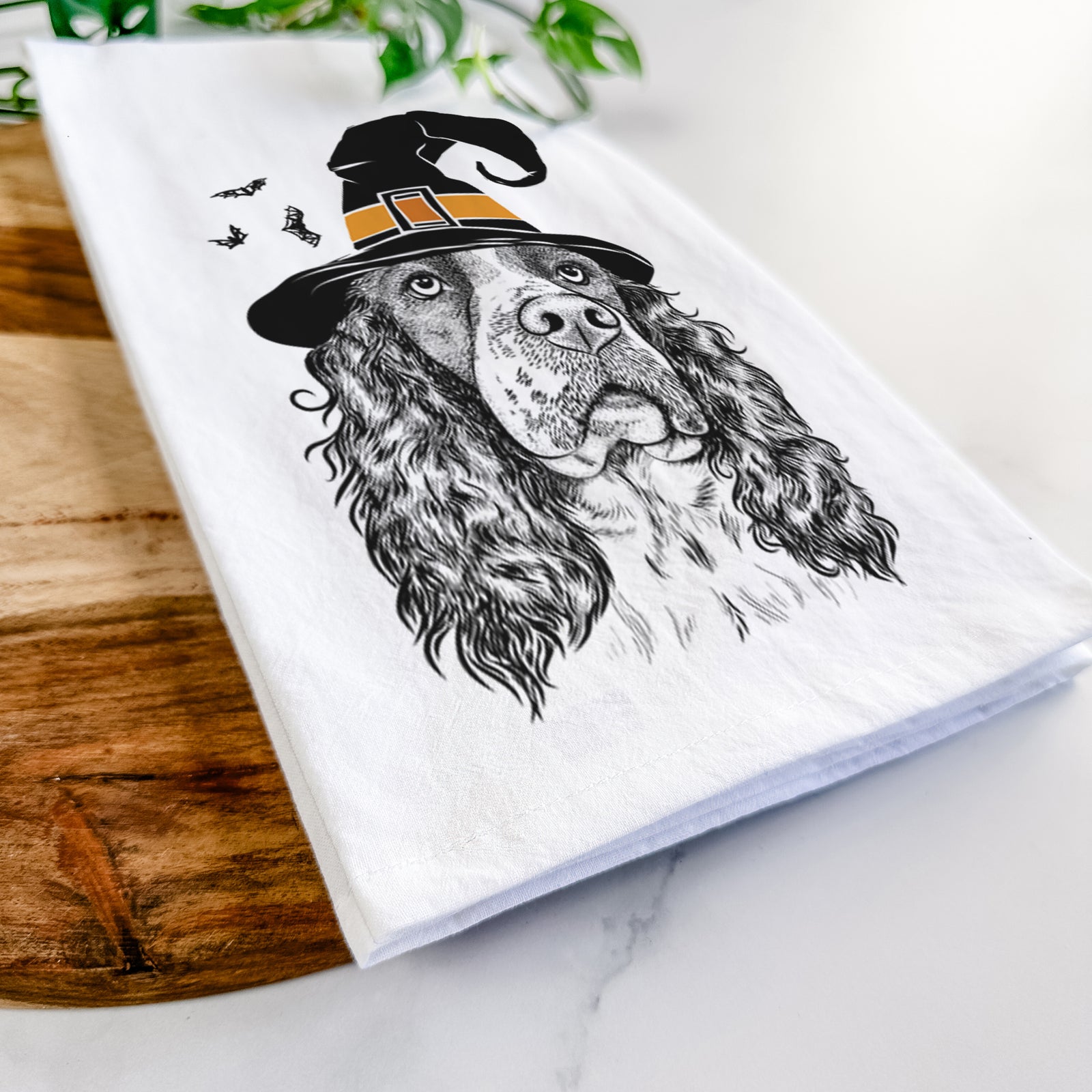 Hand-drawn sketch of Millie Mae the English Springer Spaniel wearing a witch hat on a tea towel